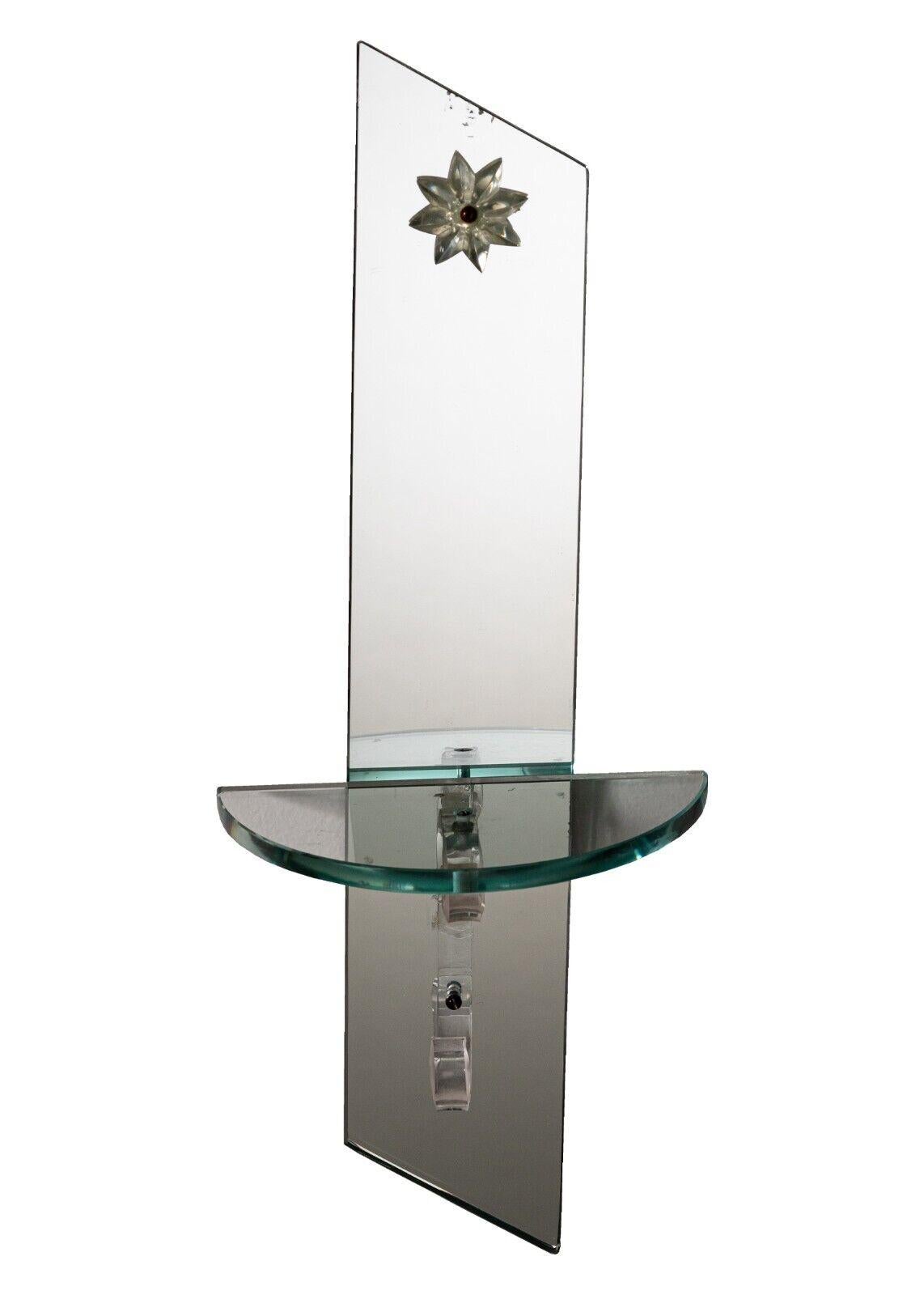 These Art Deco mirrored glass sconce shelfs are a one-of-a-kind statement piece. The intricate frames feature geometric designs with a hint of classic art deco style. The shelves are made from mirrored glass that reflects light and creates a subtle