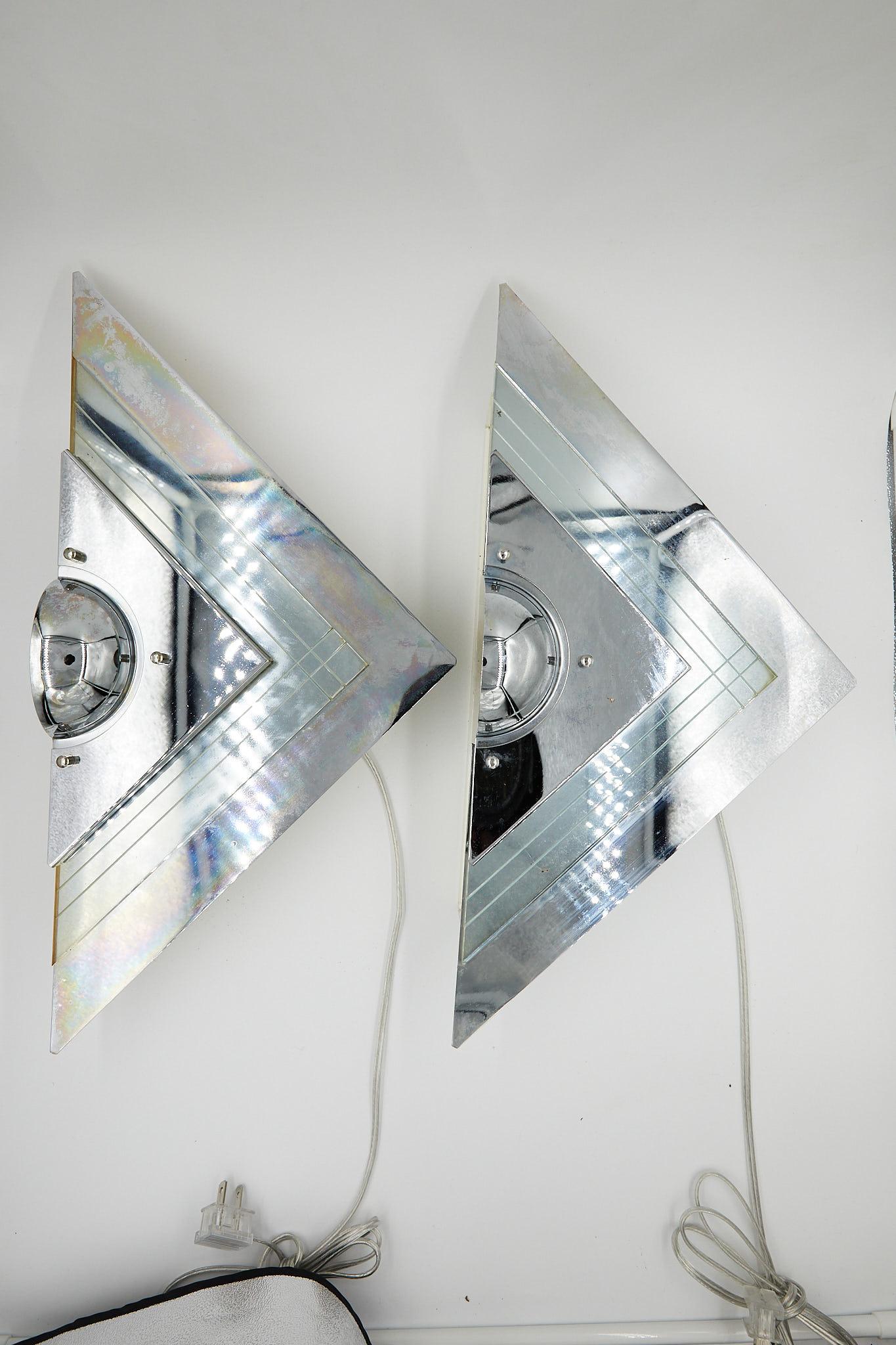 Fabulous pair of 20th century wall lights of glass and chrome by German designer Franz Hustadt for Hustadt Leuchten Manufacturing. The V-shaped floating sconces have reflective chrome backplates layered with a decorative piece of etched glass and