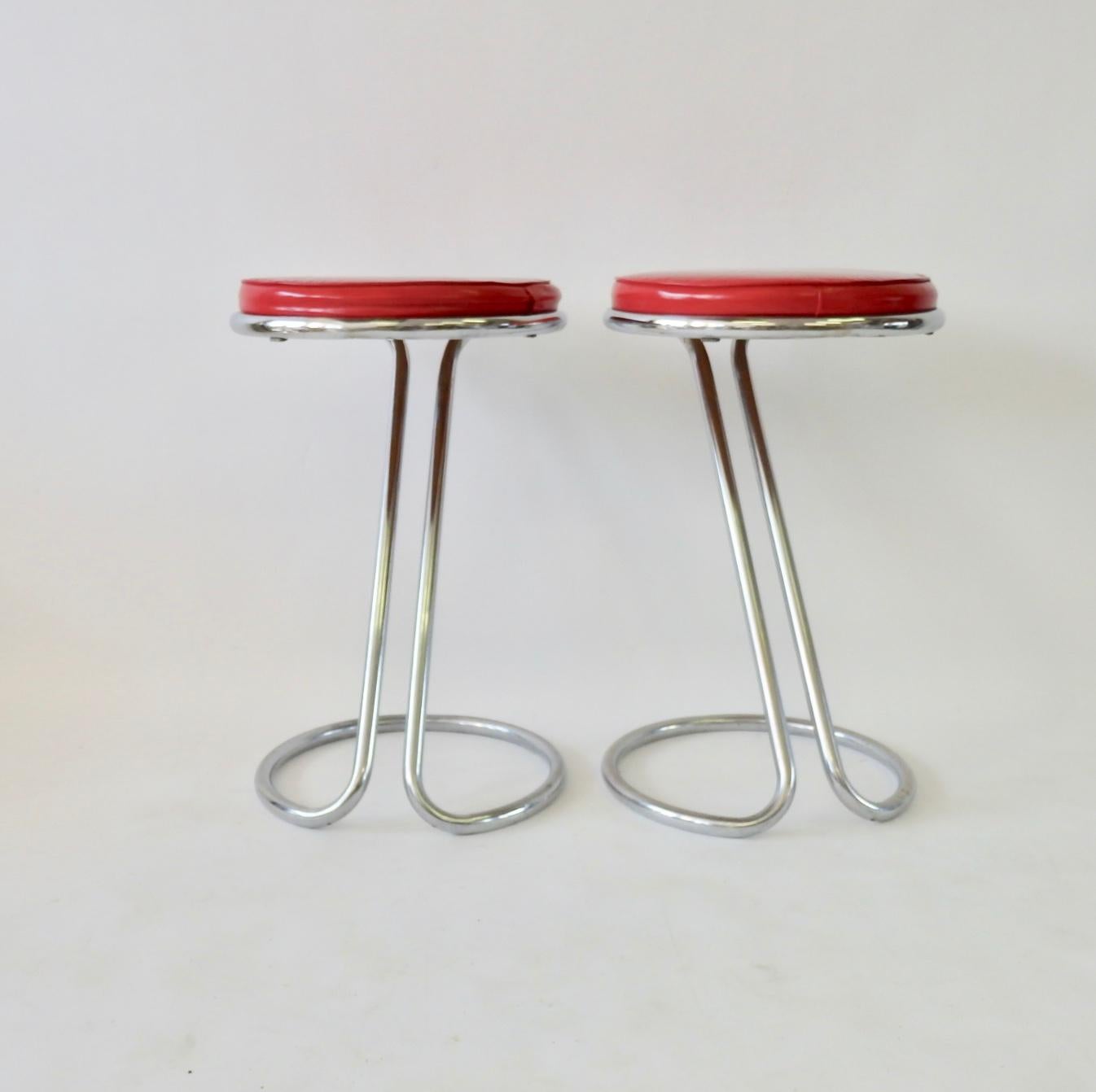 Nice original pair of Gilbert Rhode troy sunshade bar or counter stools. Early if not original red vinyl upholstery.