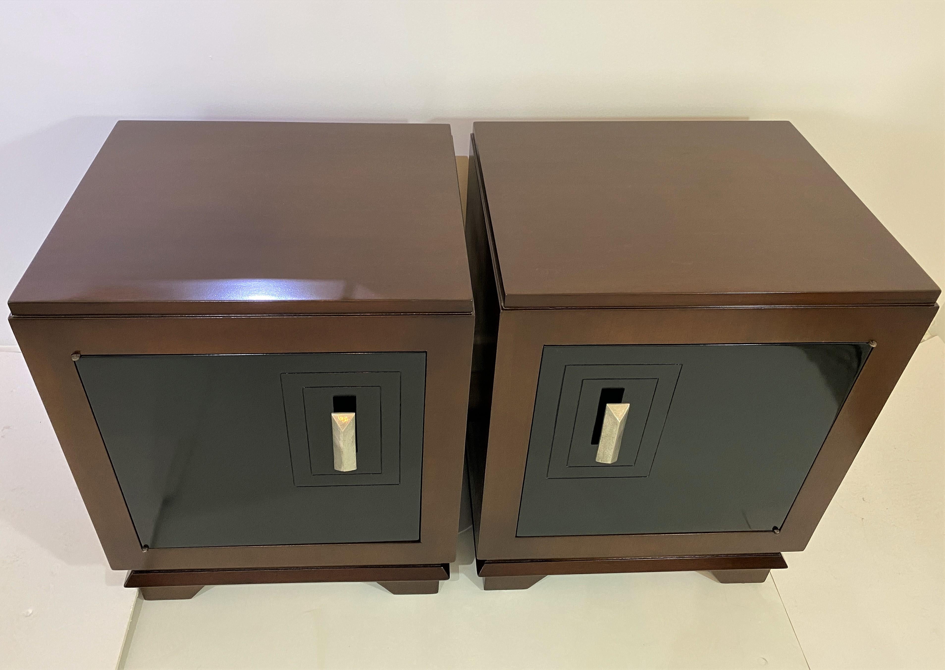 This stylish pair of nightstands seem to be transitional in their form and details. A mix of Art Deco and Moderne with clean lines and geometric forms and the combination of black lacquer and mahogany.

Note: The set has been professionally