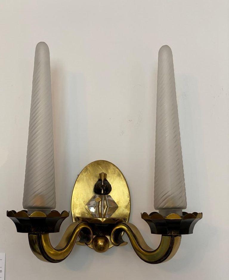 This stylish pair of wall sconces are very much in the manner of pieces created by Jules Leleu with their elongated form and use of materials. 

Note: Each require one E14 light bulb.