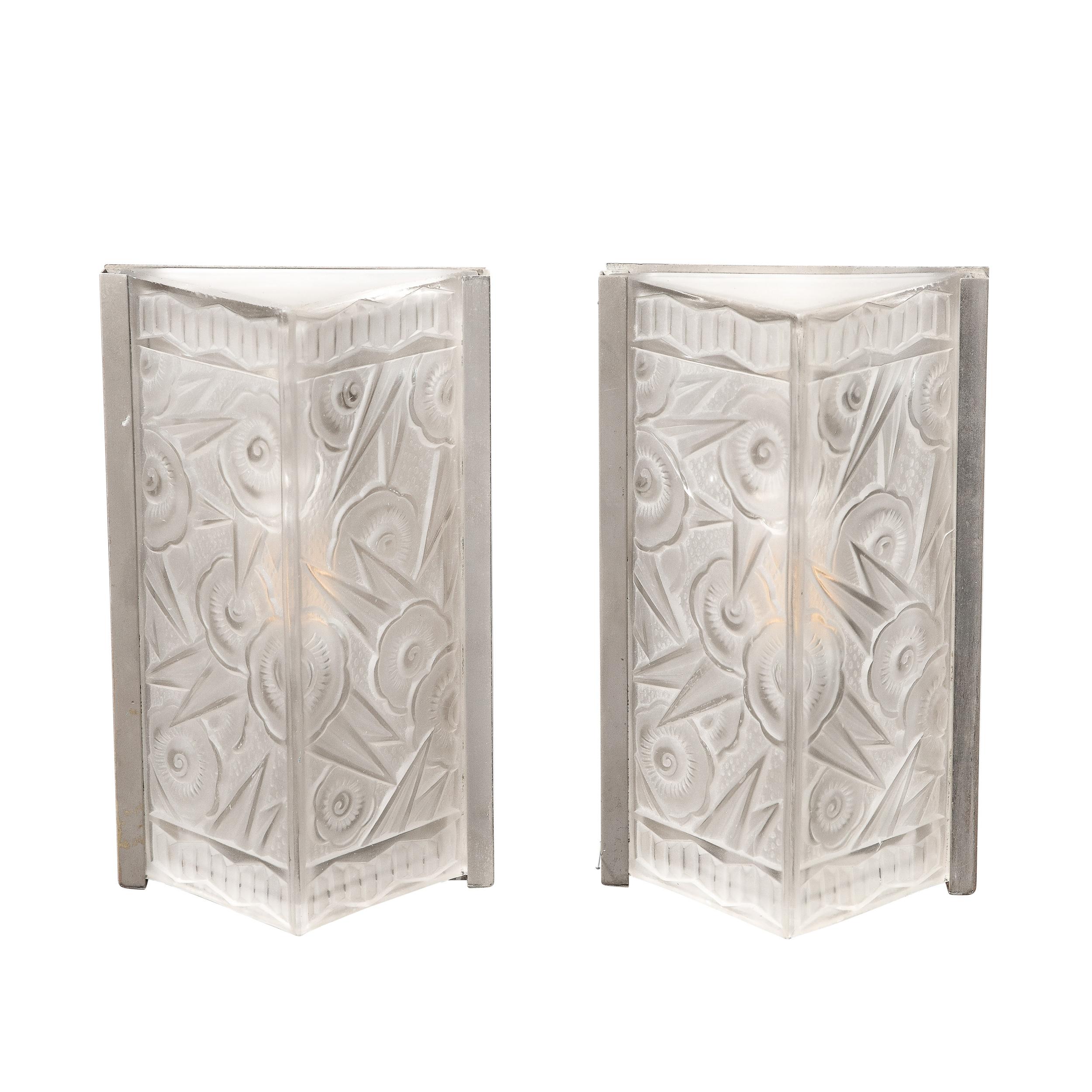 This refined pair of Art Deco Molded and Frosted Glass Sconces originate from France, Circa 1930. They feature subtle frames in nickel that house shades in the form of trainagular prisms. The frosted glass serves to diffuse light with an alluring