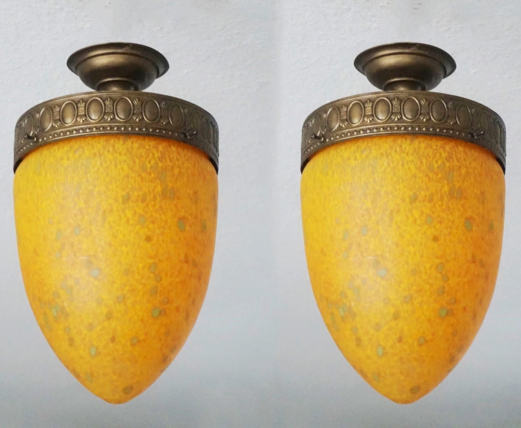 Pair of Art Deco Murano blown colored glass flush mounts with bronzed brass mounts, Italy, 1950s.
Each flush mount takes one E27 light bulb up to 100watt .
Measures: Height 14