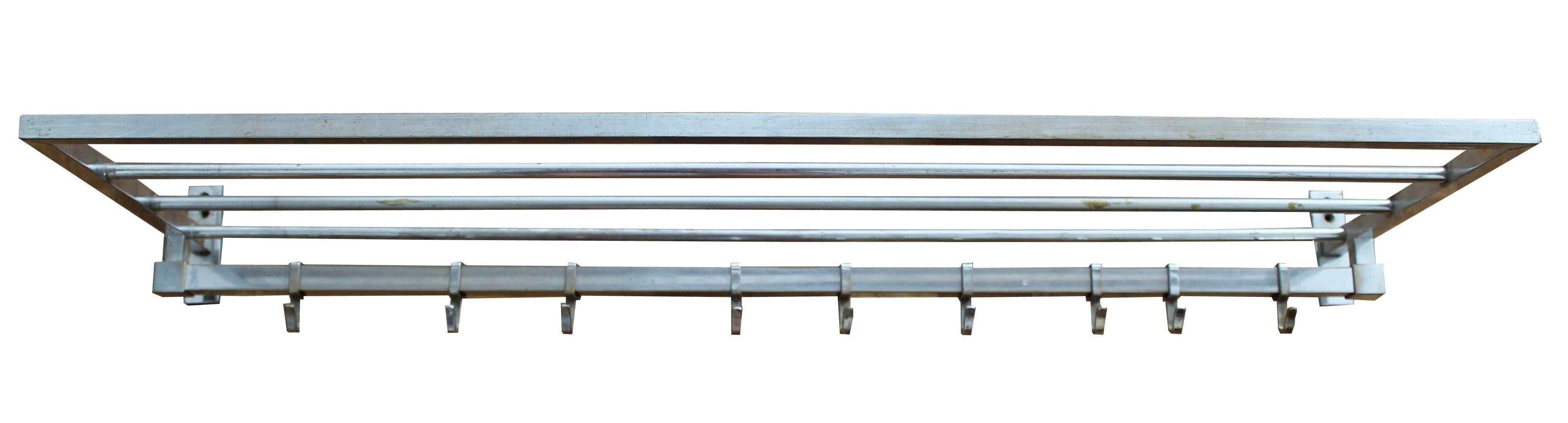 A pair of Art Deco nickel-plated brass wall hung coat racks produced in the 1930s. The pair have a minimalistic design with an eye for the practicality of everyday use. Each piece has nine hooks and a wire shelf above for storage.
This coat rack