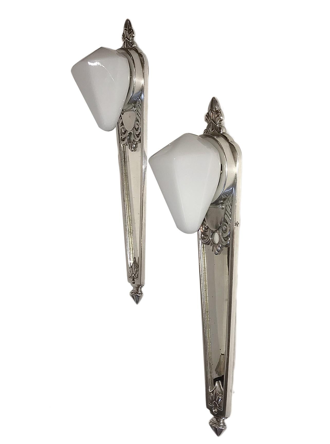 Pair of 1930s French nickel-plated sconces with milk glass shades, mirror backplate.

Measurements:
Height 15