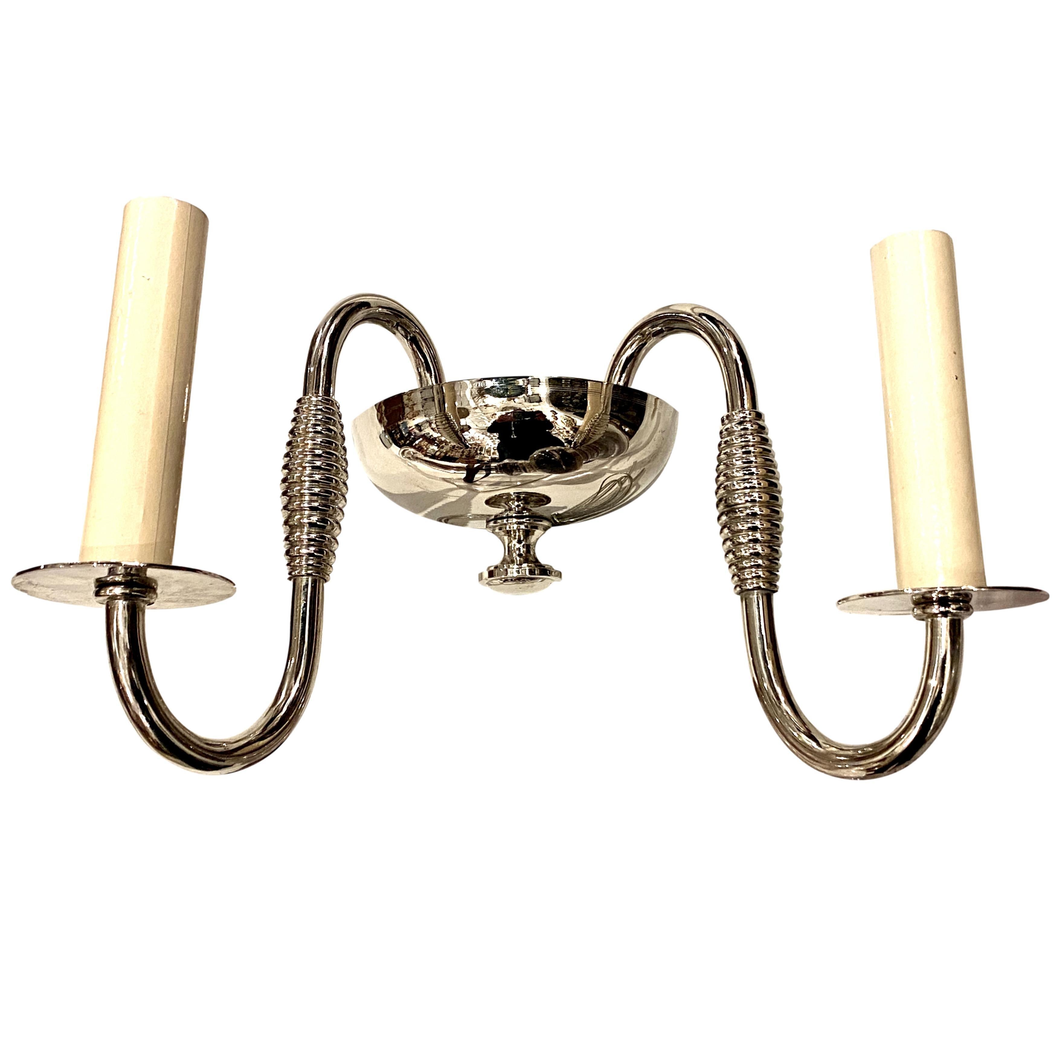 A pair of French circa 1940s Art Deco style nickel-plated two-arm sconces.

Measurements:
Height 7