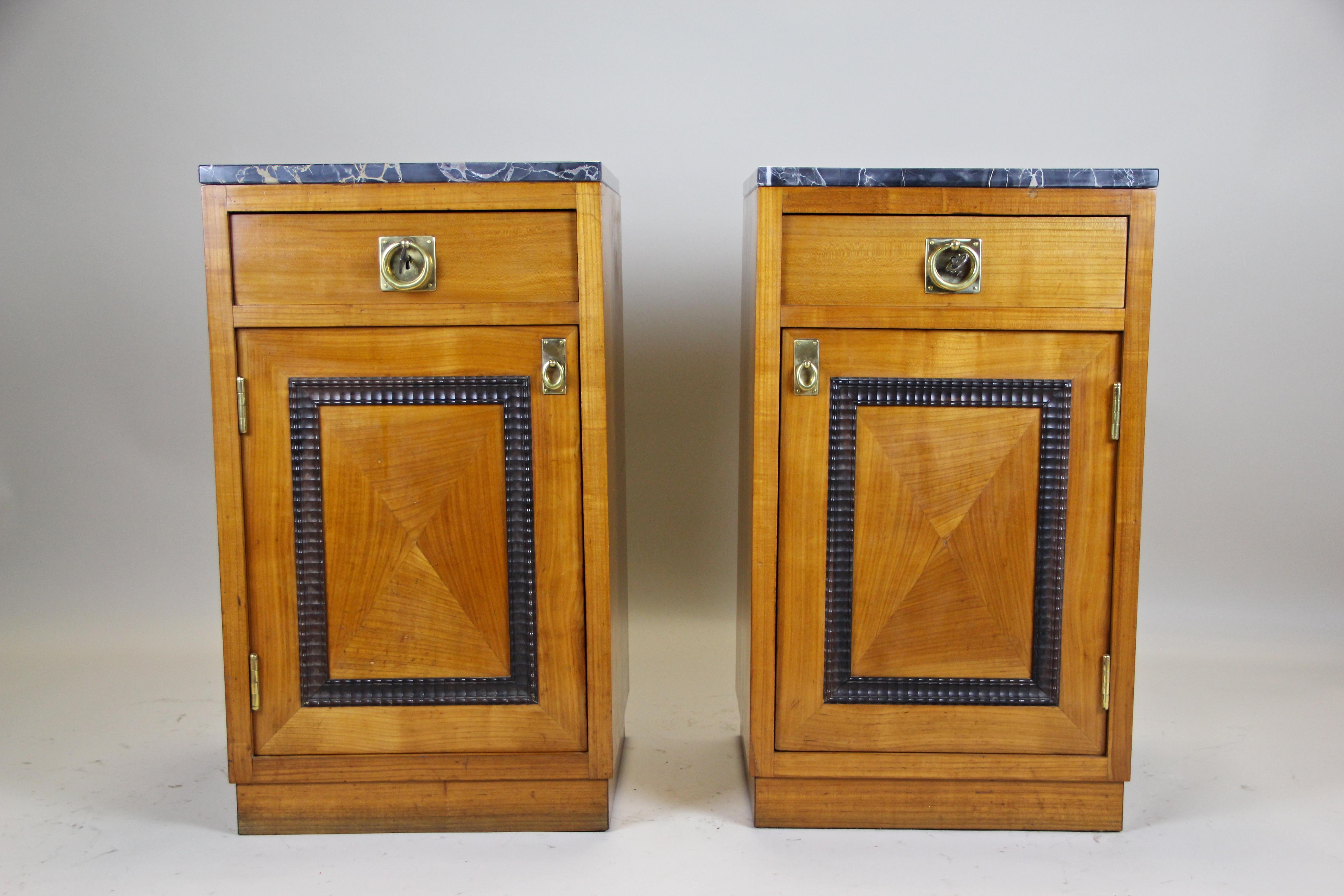 Lovely pair of Art Deco nightstands from circa 1920 out of Austria. The straight shaped matching nightstands impress with beautiful set cherrywood veneer. The doors show a great design with inserted ebonized waved bars and can be easily