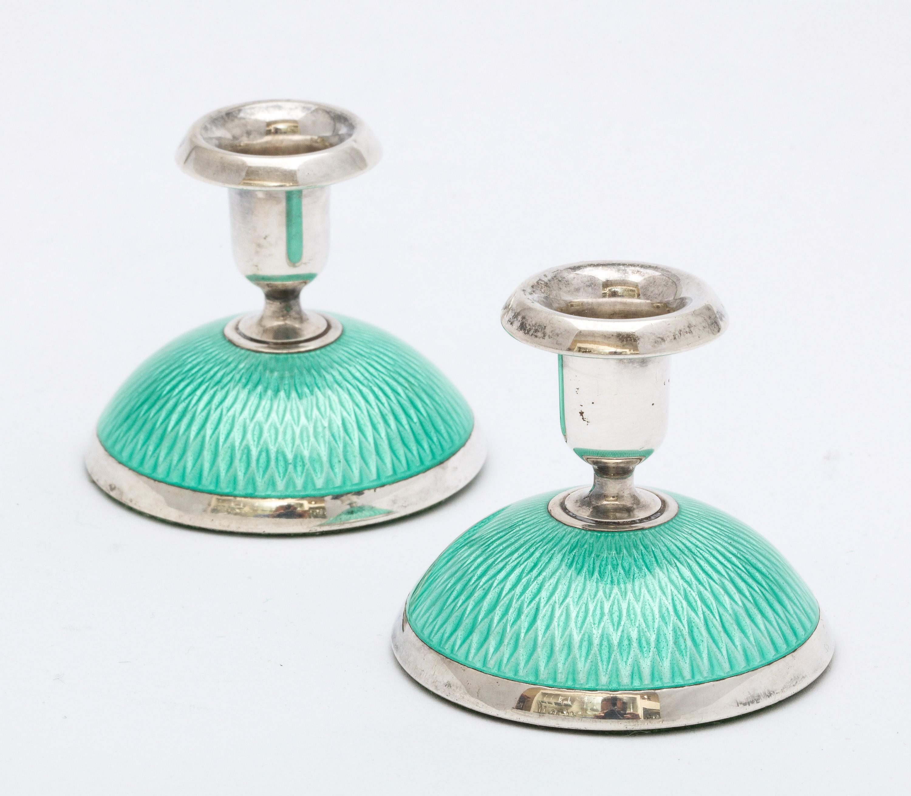 Pair of Art Deco, sterling silver and turquoise guilloche enamel candlesticks, Oslo, Norway, Ca. 1930's, 
Norsk Solwarreindustri - makers. Each candlestick measures 2 inches high x 2 inches diameter (across base). Underside of each candlestick is