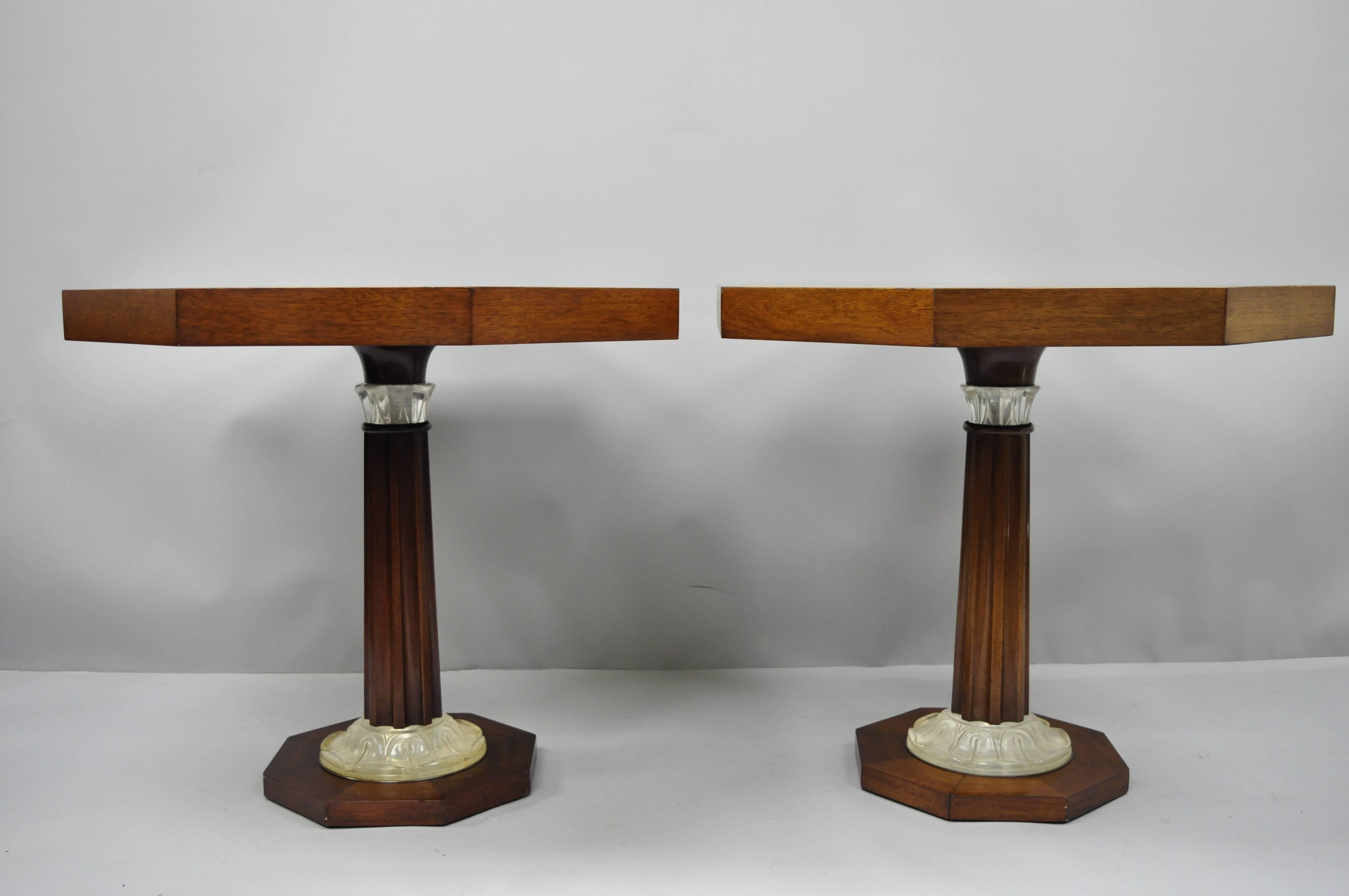 A pair of Art Deco French style octagonal mahogany pedestal base side tables with acrylic, Lucite accents attributed to Grosfeld House. Item features sunburst inlaid mahogany top, carved column pedestal base with acrylic leafy accents to the columns