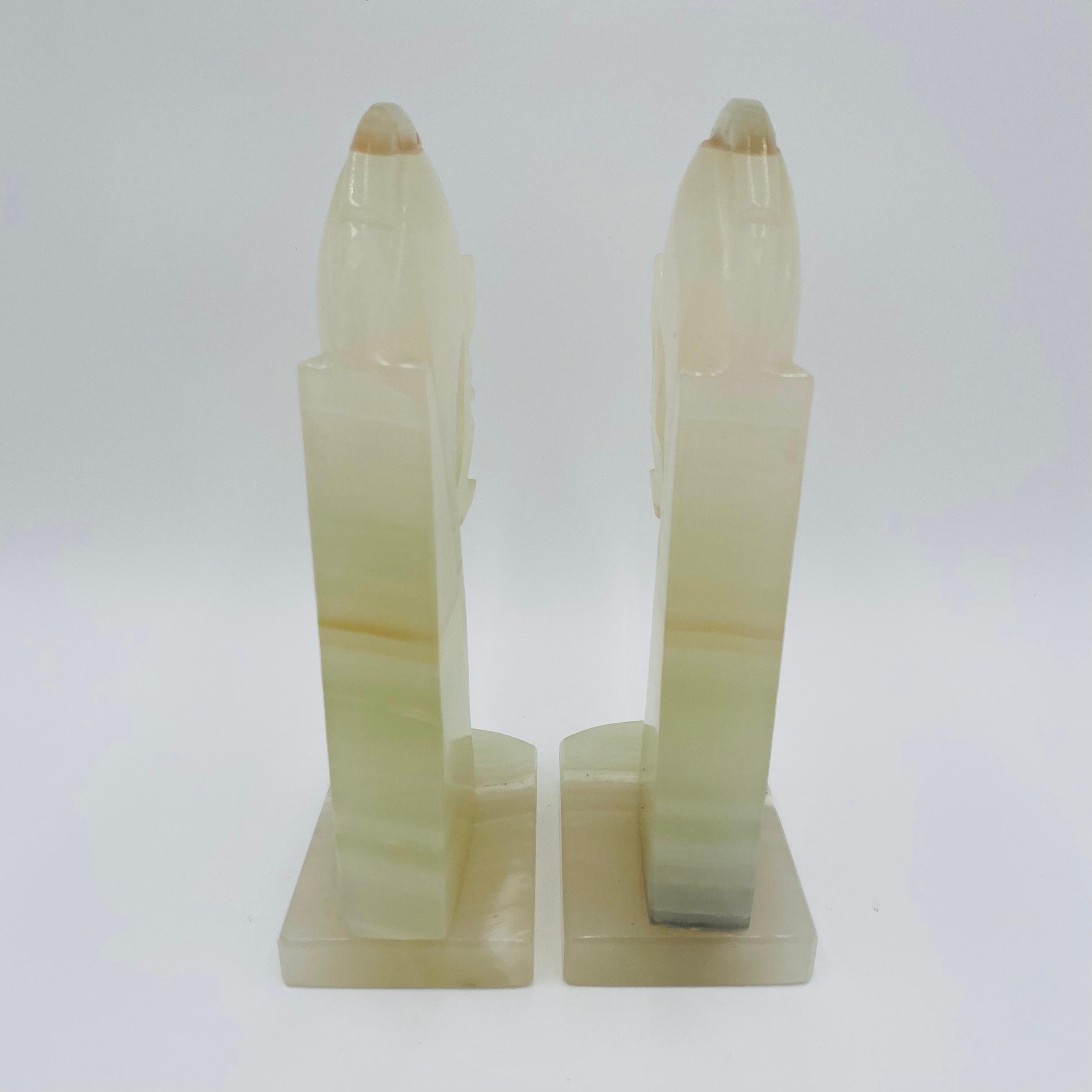 This is a pair of vintage Art Deco stylized horse head bookends, hand carved in onyx with shades of ivory, brown, and green.
In the style of Hermès, it is a great modern design.
