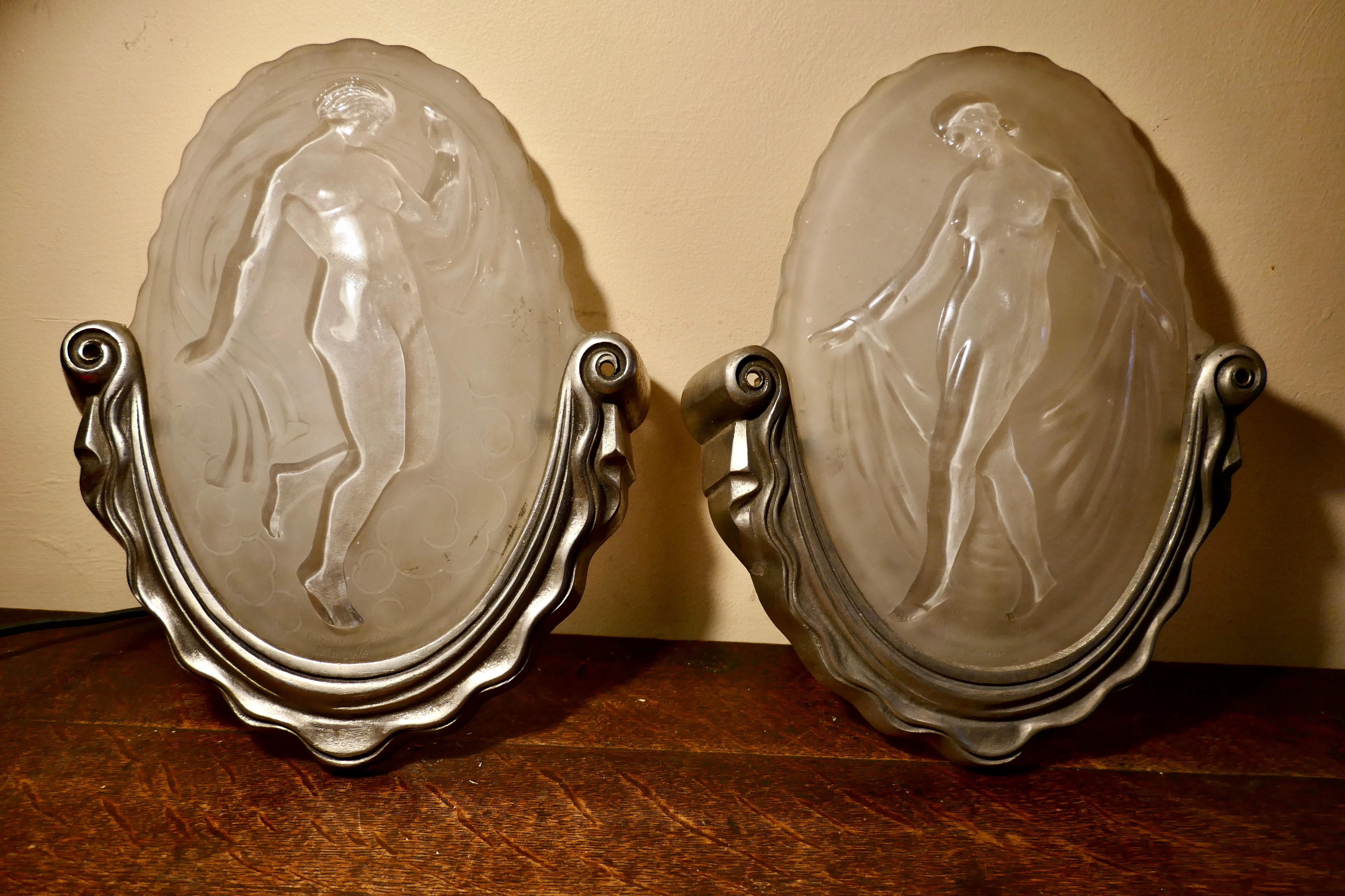 Pair of Art Deco Opaque Glass Light Shades by Muller Freres Luneville

A rare pair of Opaque glass lamp shades, with beautifully detailed dancing nudes both shades  are signed by Muller Brothers of Luneville, they are set in the original pewter