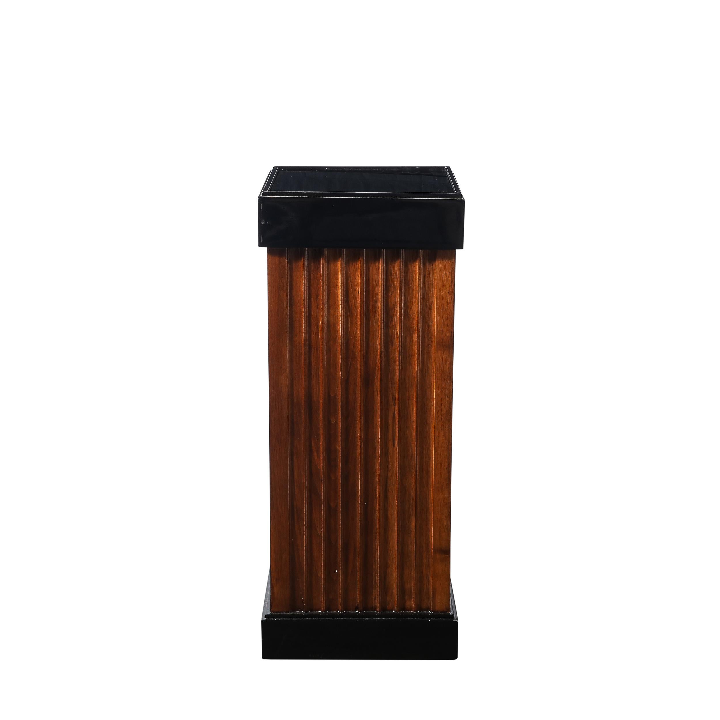Questa eccezionale coppia di piedistalli Art Deco, dalle dimensioni meravigliose, mette in mostra i principi del design audace e snello degli anni Trenta. Realizzati in noce scanalato, questi pezzi sono una miscela magistrale di texture naturale,