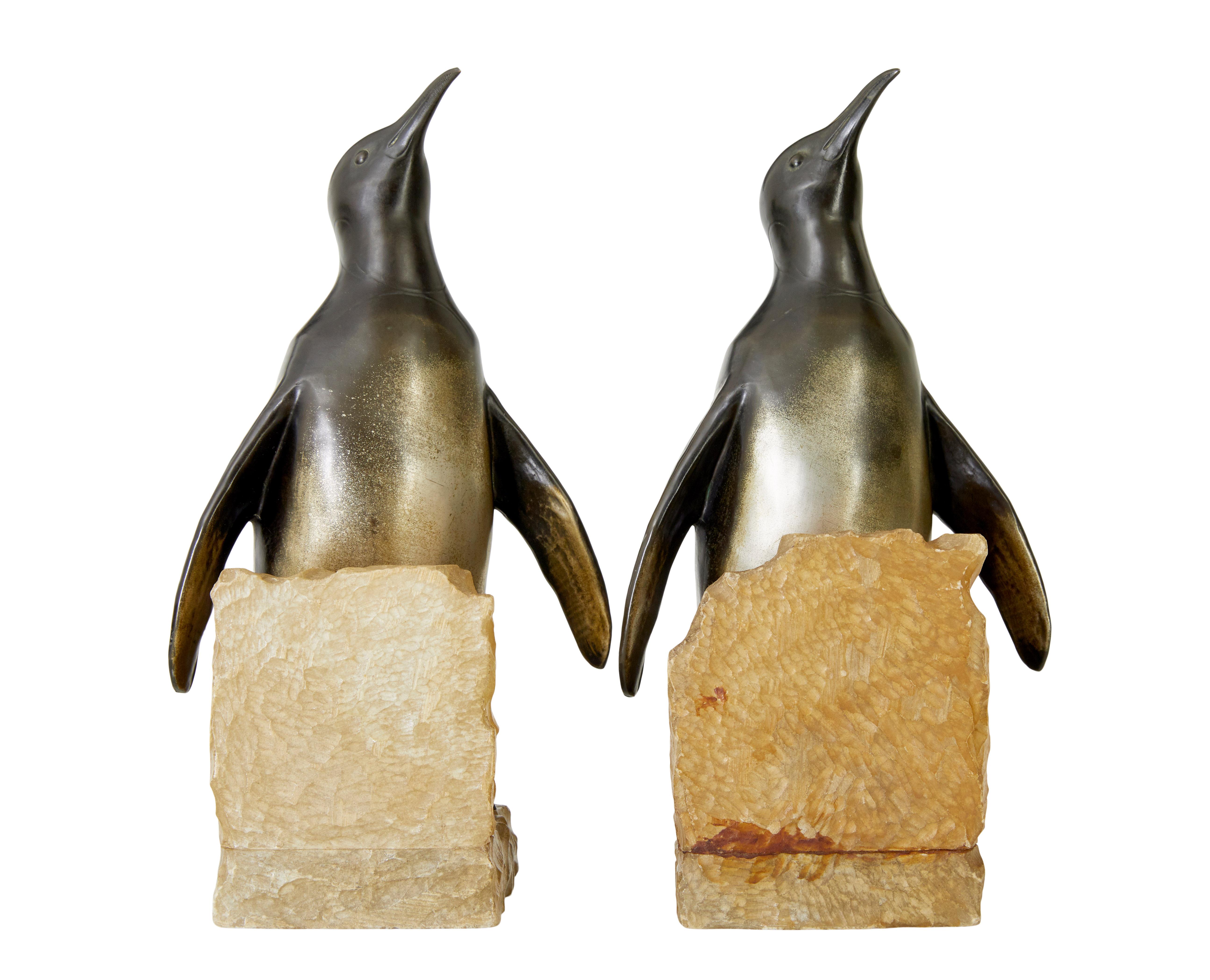Pair of Art Deco penguin and alabaster book ends circa 1920.

Beautiful pair of deco period bookends, made in spelter and superbly cast with cold painted gold bellies.  Mounted on alabaster l shapes.  Timeless pieces that will suit most interiors