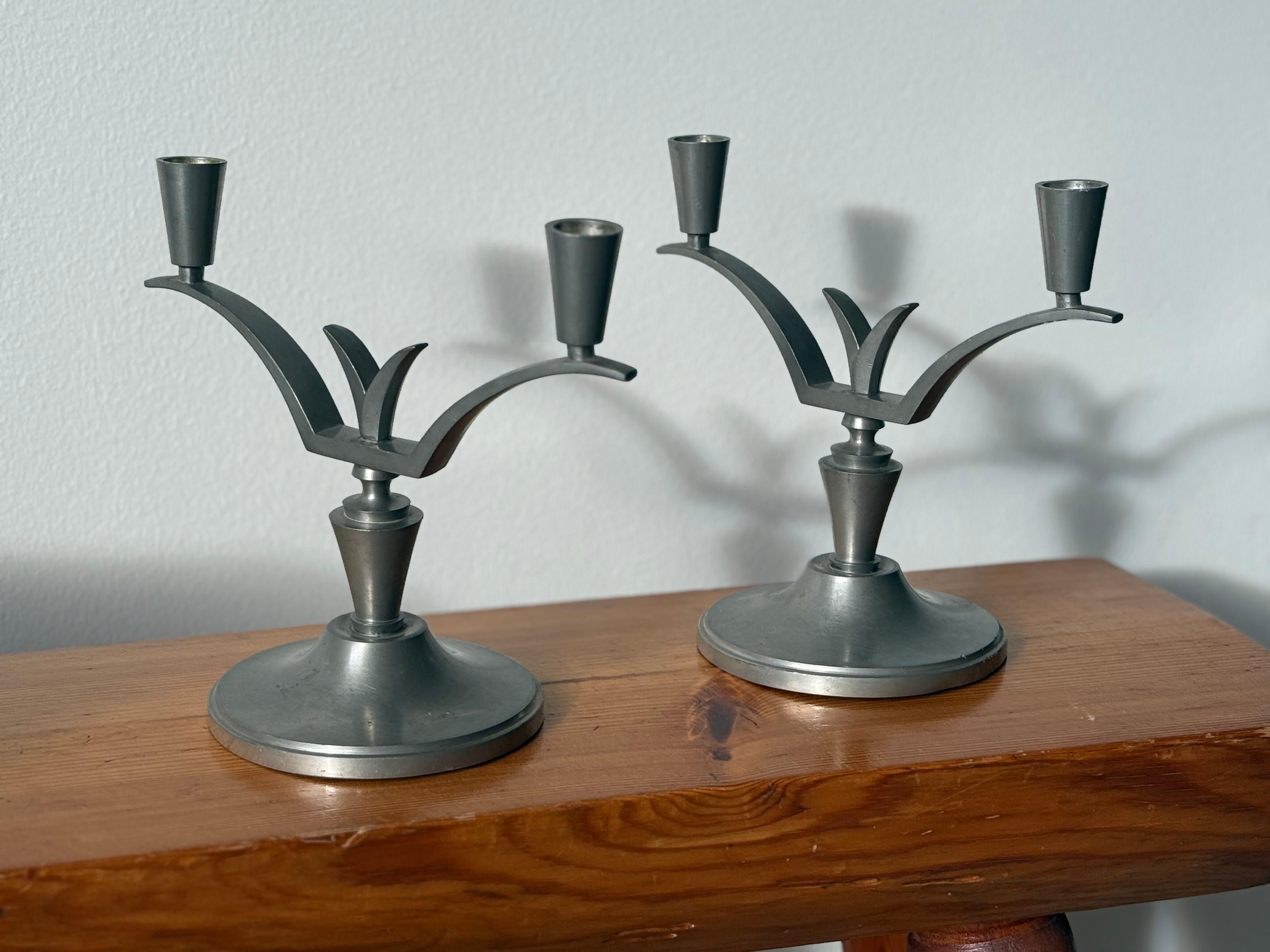 An elegant pair of Swedish Art Deco pewter candelabras from the 1930s, combining sculptural symmetry with the refined minimalism. The design reflects the period’s transition from classic Art Deco to Scandinavian functionalism, with clean curves and