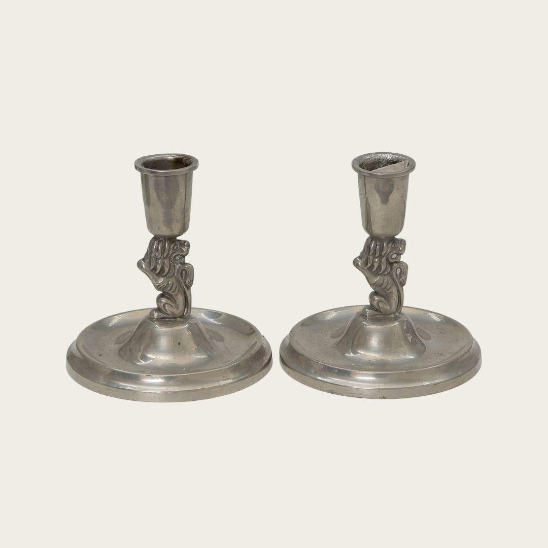 These 1930s Swedish candlesticks feature lions linking the candlesticks to their bases. They are marked with CG Hallberg on the underside.
