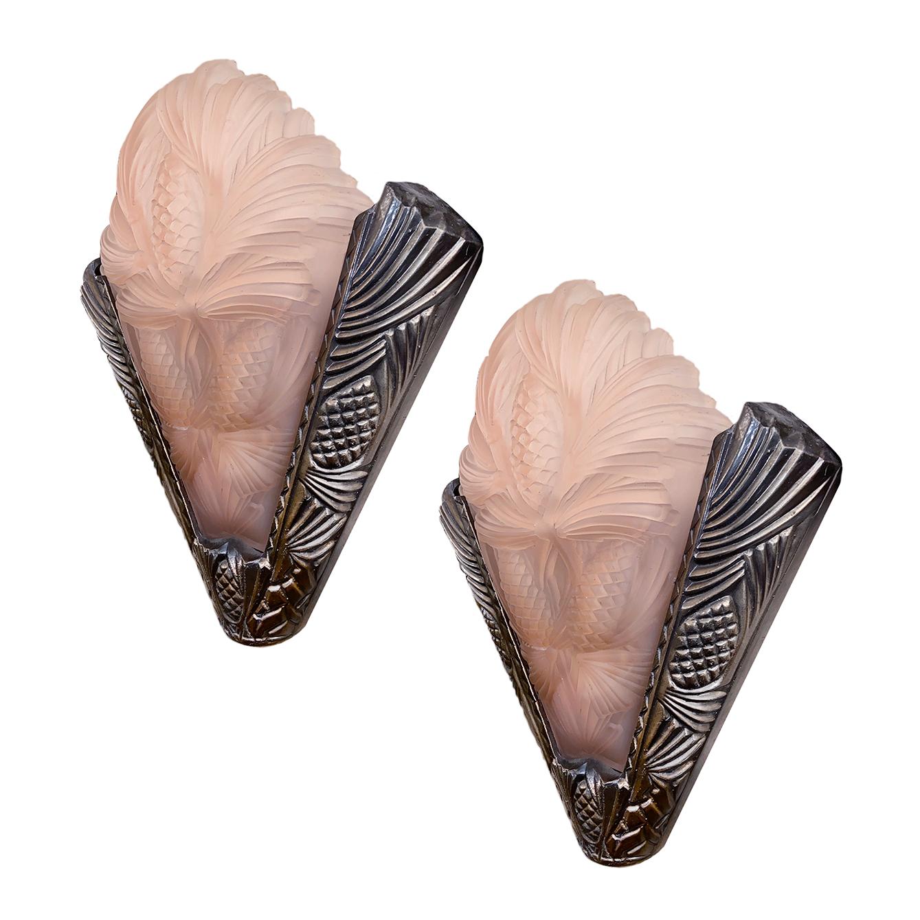 Pair of circa 1940s French pewter and pink glass sconces with interior light.

Measurements:
Height 17