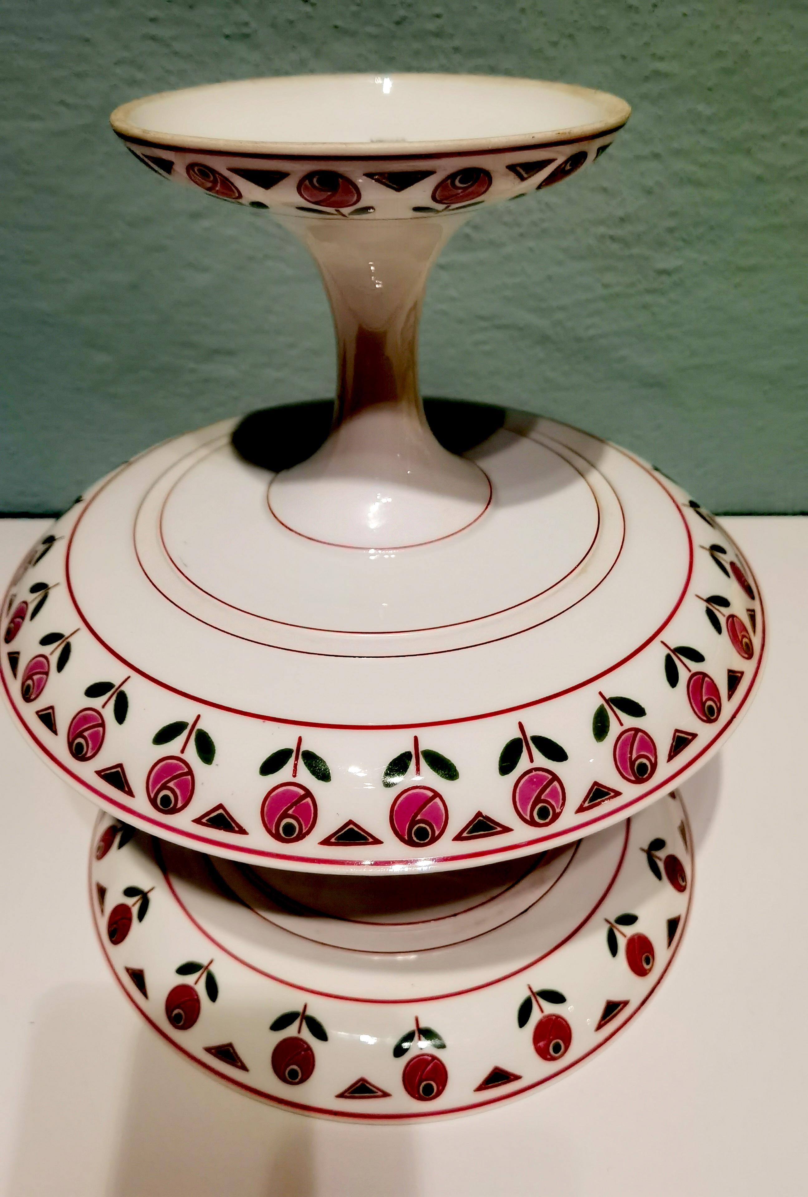 Pair of Art Deco porcelain fruit stands in slightly different seizes. Hand-painted in green and pink colors with a rim of roses. Also backside painted. 1 stand stamped Limoges France, 1 stand stamped A. Anternier & Co Limoges Limoges