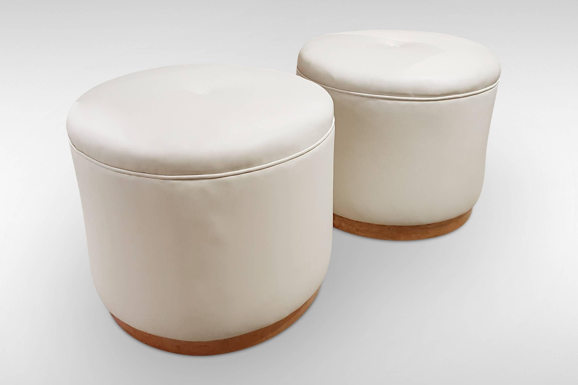 A pair of stylish Art Deco Pouffe stools or seats in cream faux leather on maple veneer bases,
circa 1930s-1950s.