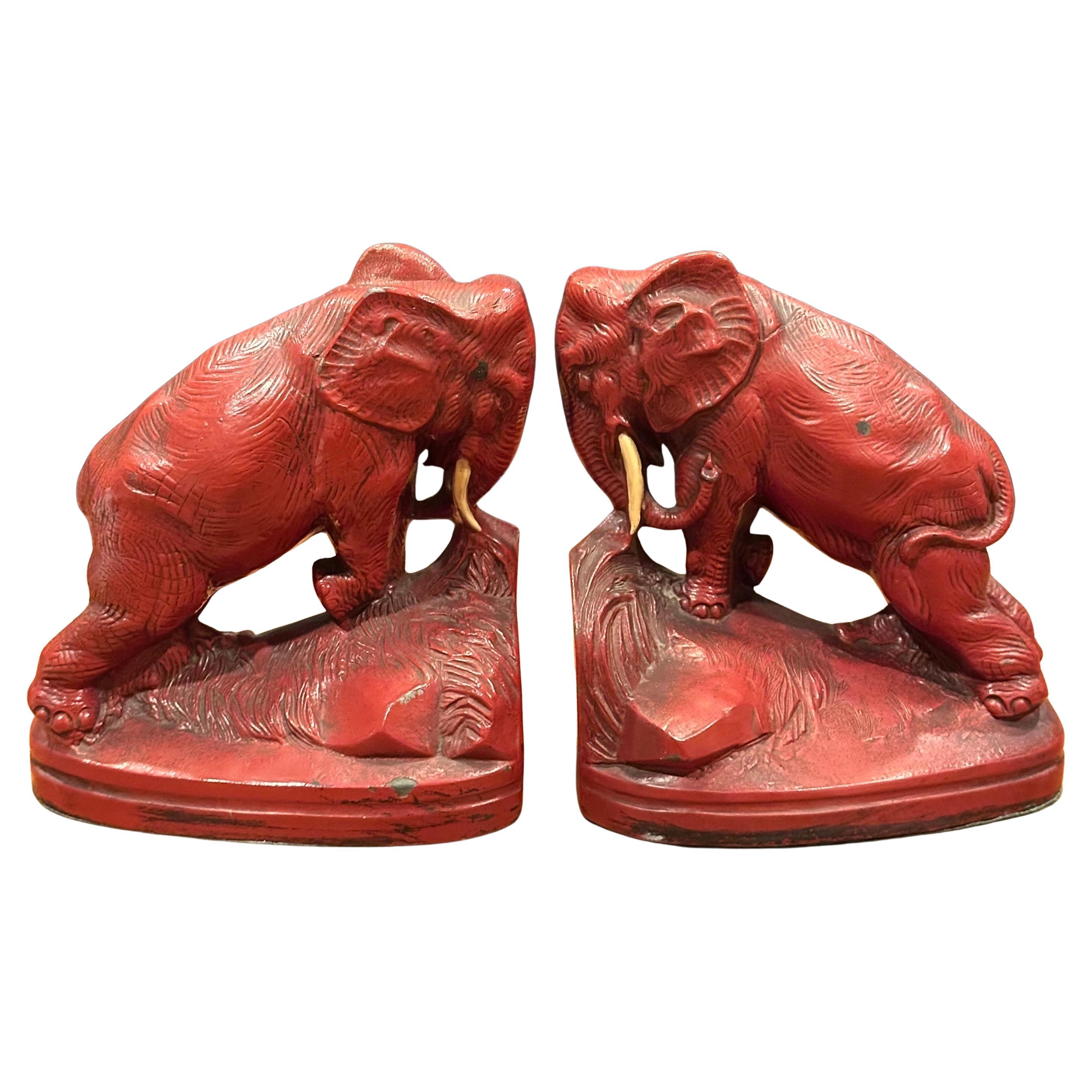 A very nice and hard to find pair of Art Deco red painted metal charging elephant bookends., circa 1930s. The bookends  are in original condition with a fine patina, some light oxidation and some surface scratches (also marked with a black Sharpie -