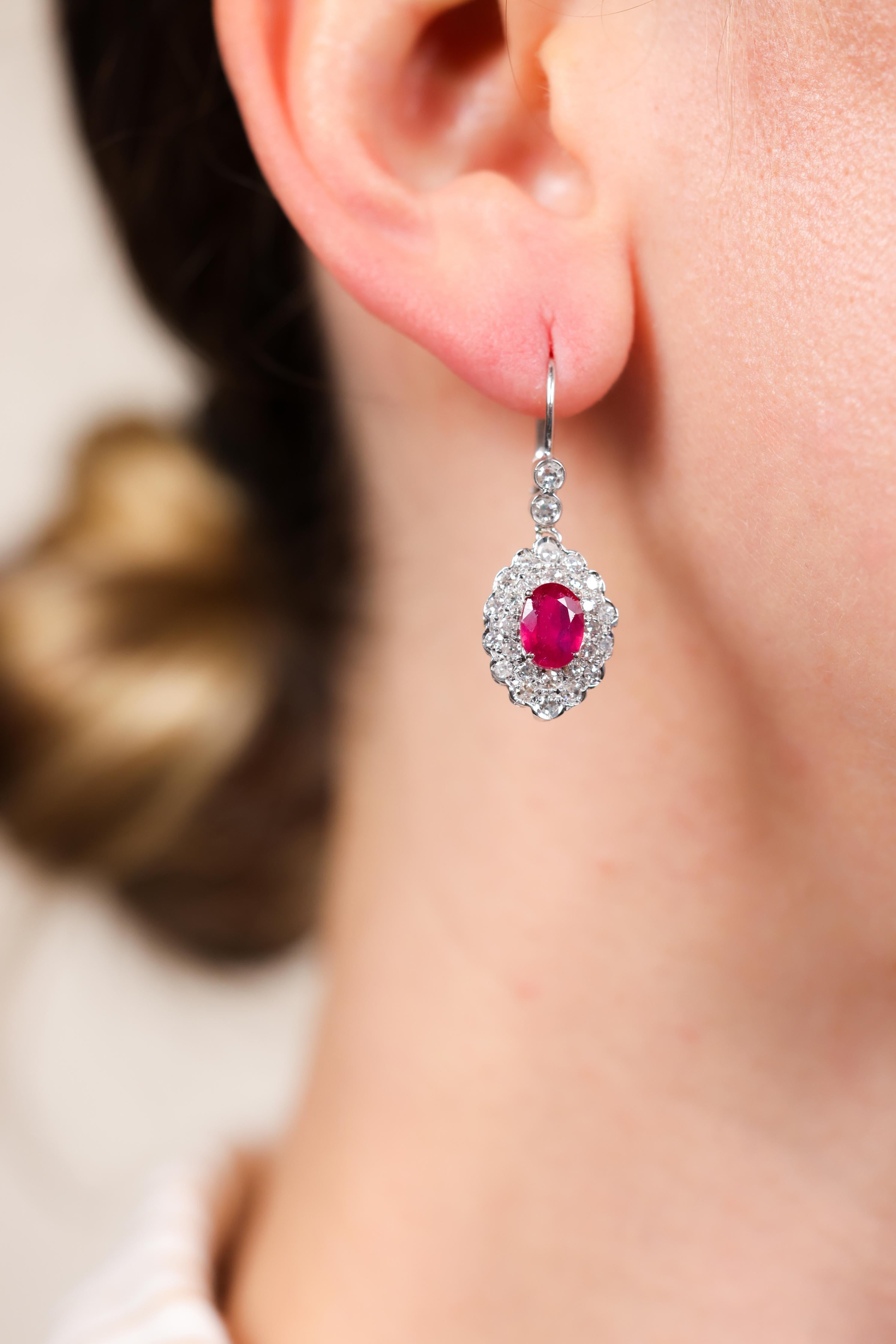 One Pair of Art Deco Revival Ruby Diamond 18k White Gold Drop Earrings. Featuring two oval mixed cut rubies with a total weight of approximately 2.10 carats. Accented by 56 single cut diamonds with a total weight of approximately 2.80 carats, graded