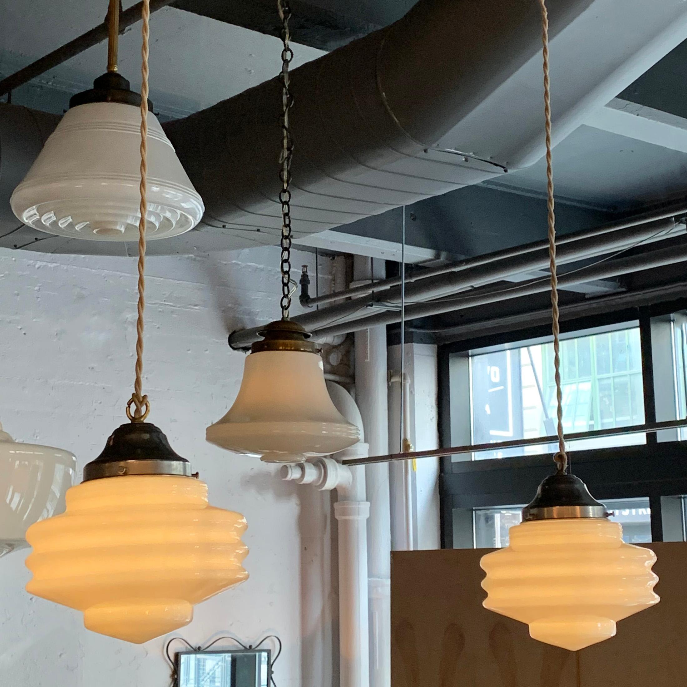 Pair of art deco, ridged milk glass pendant lights with aluminum fitters are newly wired with 64 inches of braided cloth cord to accept up to 150 watt bulbs.