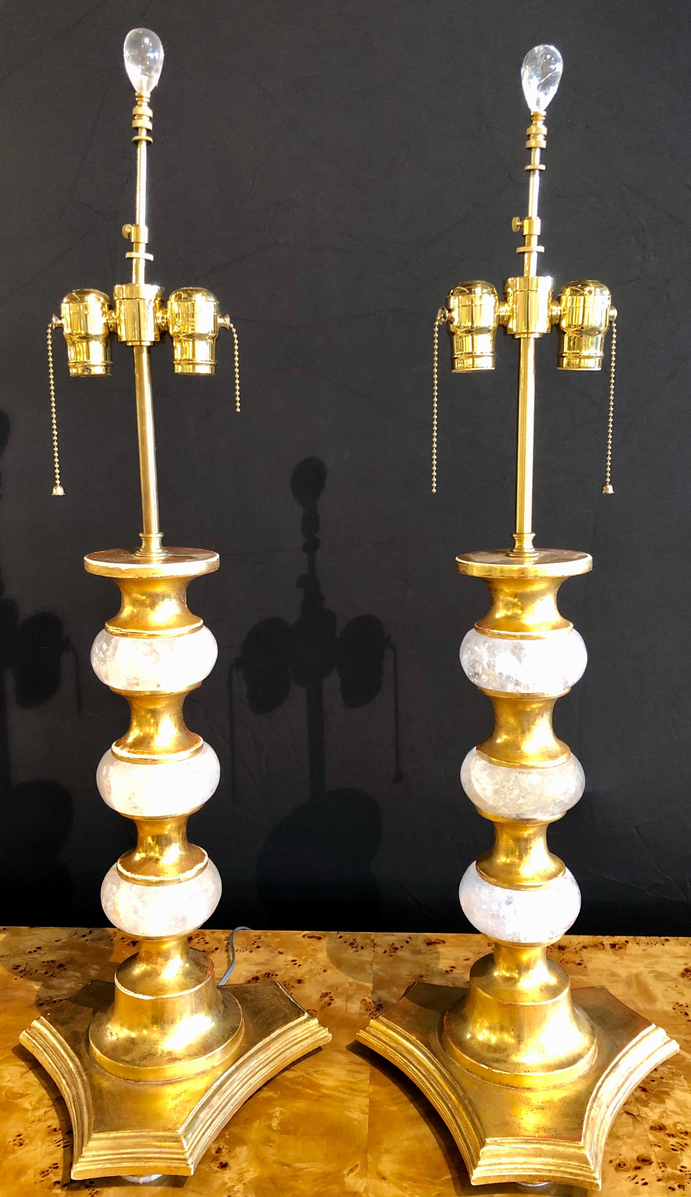 Pair of Art Deco style rock crystal table lamps. The fine oval round crystals separated by gilt wood supports. The pair with a set of rock crystal finials. Lamps do not come with shades. Newly wired.
PXX.