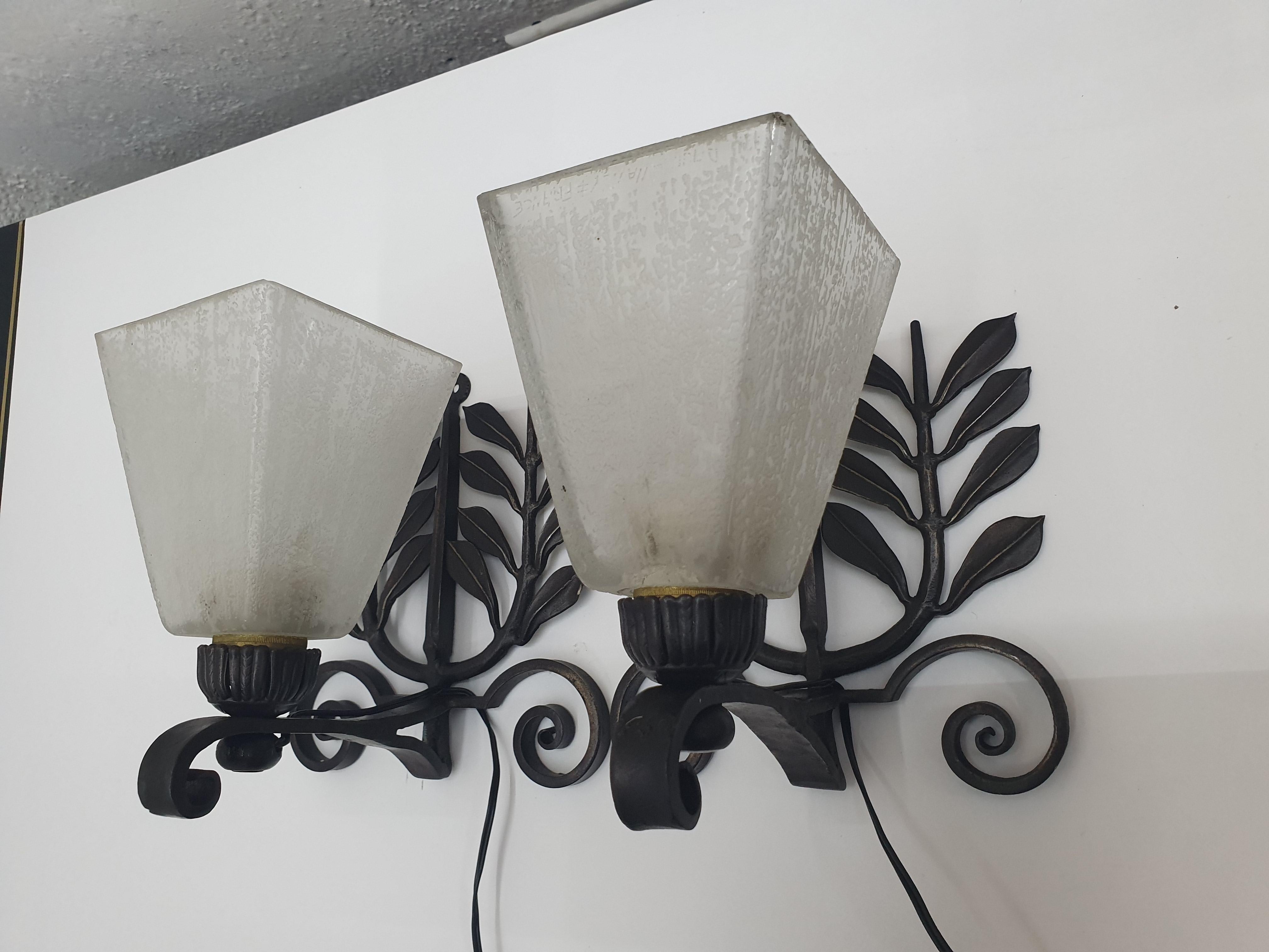 Beautiful pair of Art Deco wrought iron sconces by Edgar Brandt, both are stamped in the back 