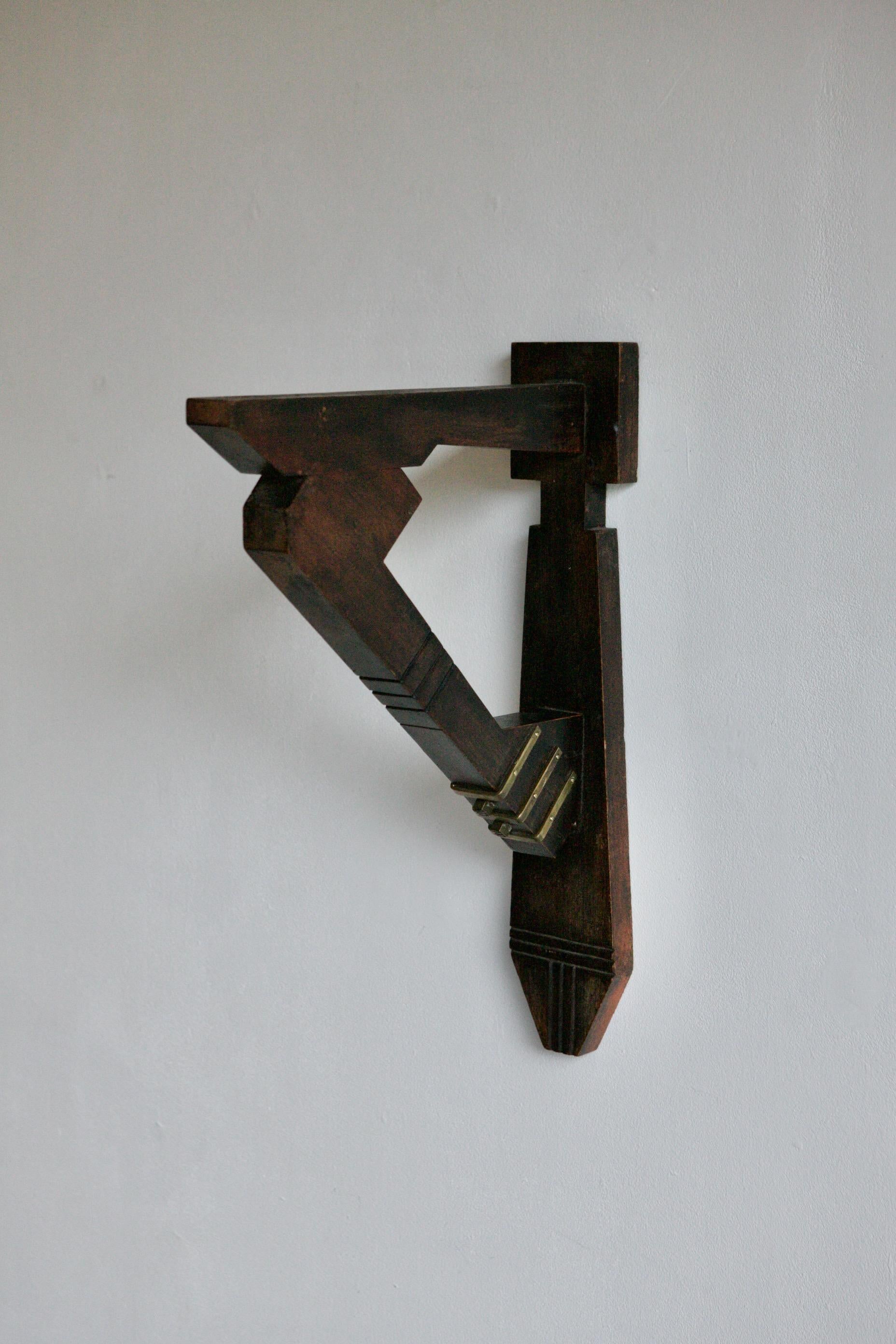 We have for sale two pairs of these incredible wall brackets by Adolphe Petit-Monsigny. A rare find from French Art Deco sculptor who was renowned for his work in brass and other metals. These deep brackets made from mahogany and brass have an