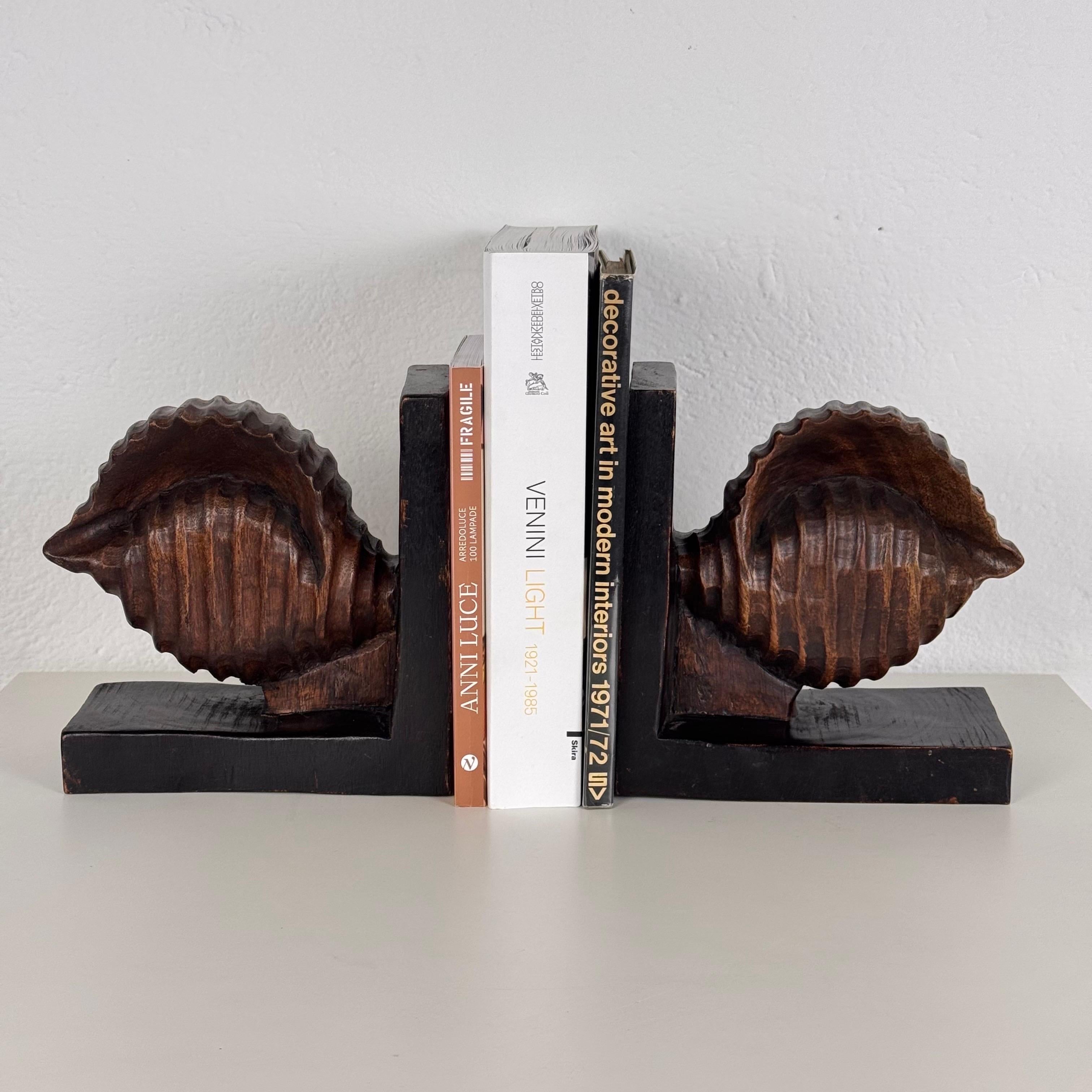 Step into timeless elegance with this exquisite pair of Italian Art Deco bookends from the glamorous 1930s. Meticulously hand-carved from rich beech wood, each piece is sculpted into refined, captivating shell forms that radiate sophistication and