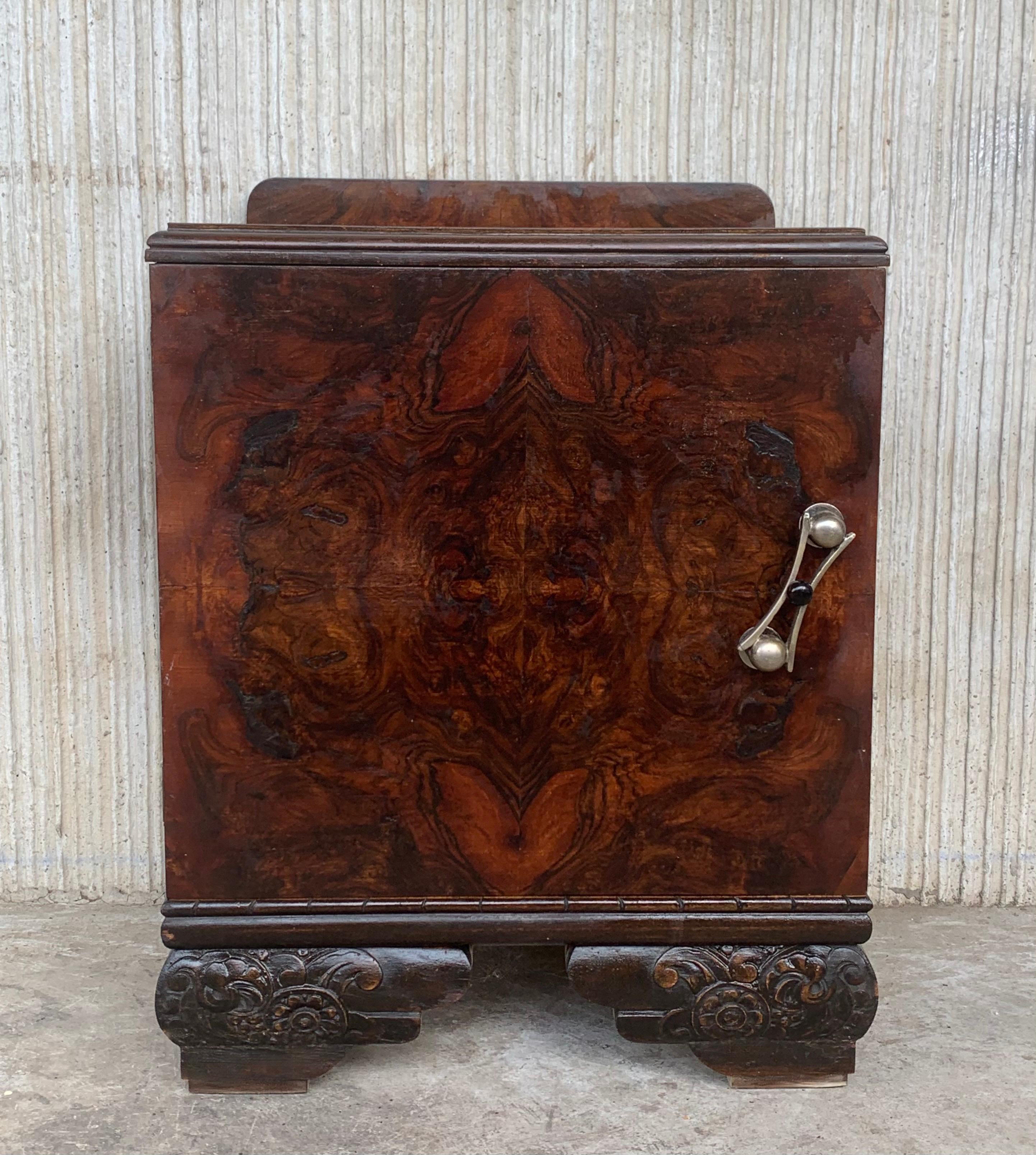 This pair of circa 1930s French Art Deco side cabinets could be used to flank a sofa or as nightstands. Each has a storage compartment with hinged door and narrow open shelves at the sides. One-drawer and one box. Cabinets are set on ebonized