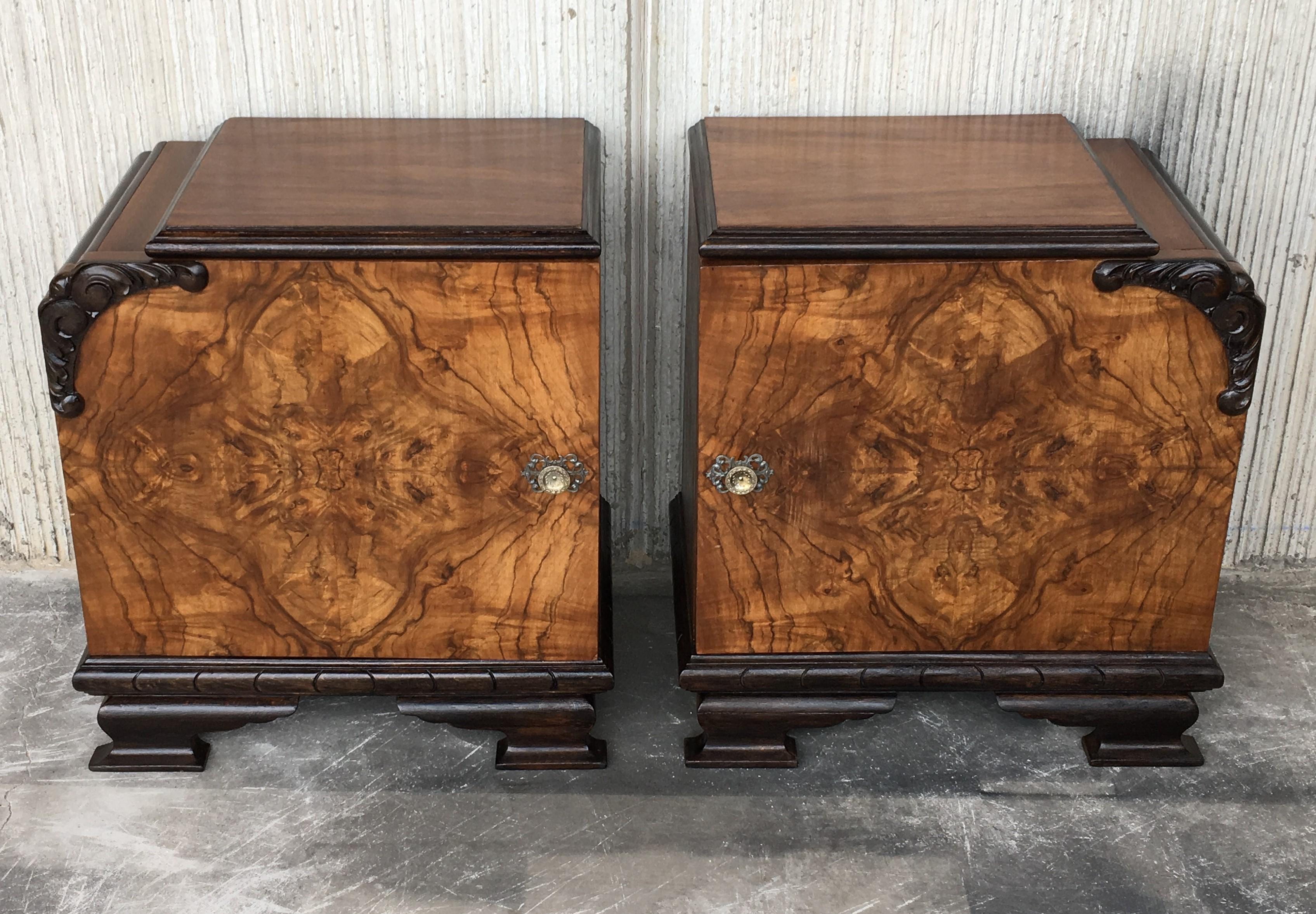This pair of circa 1930s French Art Deco side cabinets could be used to flank a sofa or as nightstands. Each has a storage compartment with hinged door and narrow open shelves at the sides. One-drawer and one ceramic box. Cabinets are set on