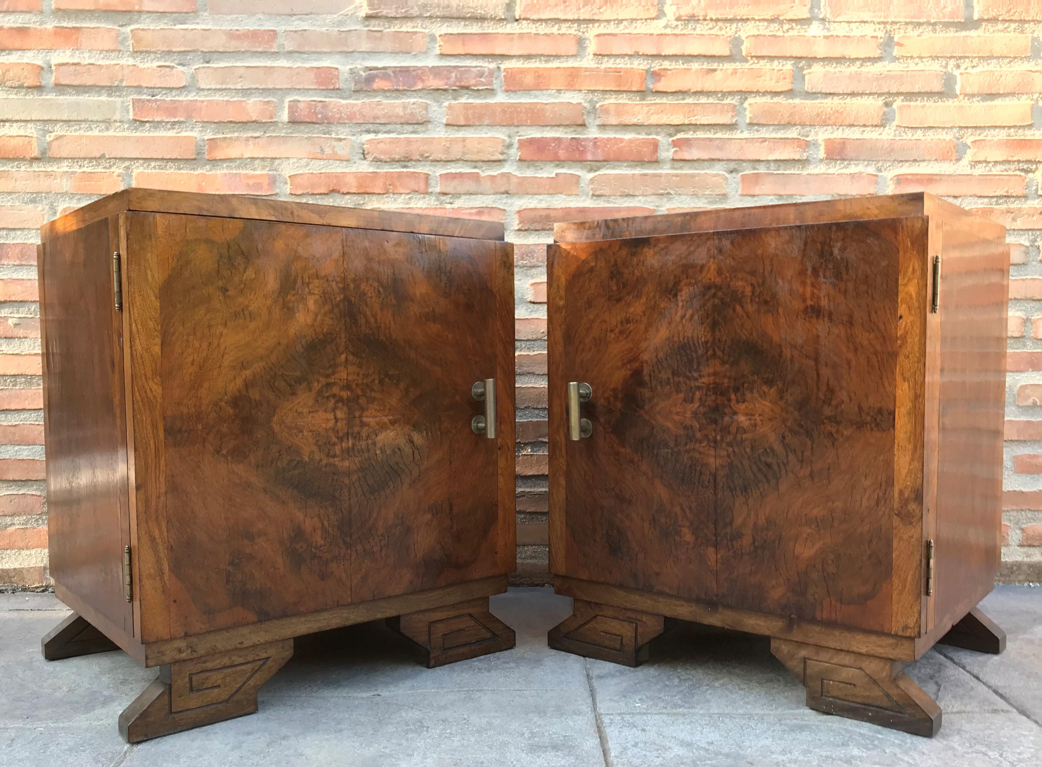 This pair of circa 1930s French Art Deco side cabinets could be used to flank a sofa or as nightstands. Each has a storage compartment with hinged door and narrow open shelves at the sides. One-drawer and one box. Cabinets are set on ebonized