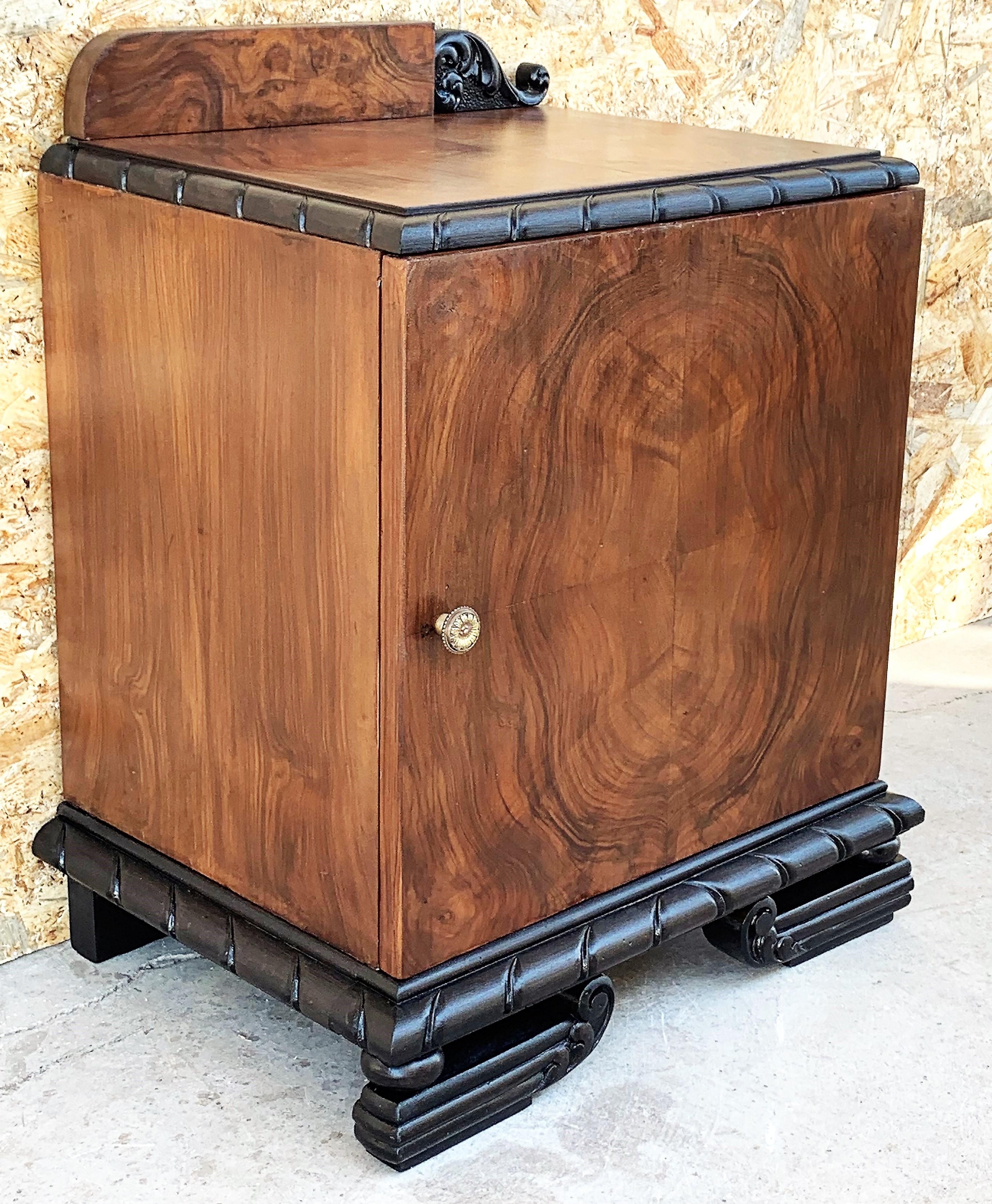 This pair of circa 1930s French Art Deco side cabinets could be used to flank a sofa or as nightstands. Each has a storage compartment with hinged door and narrow open shelves at the sides. One-drawer and one box. Cabinets are set on ebonized