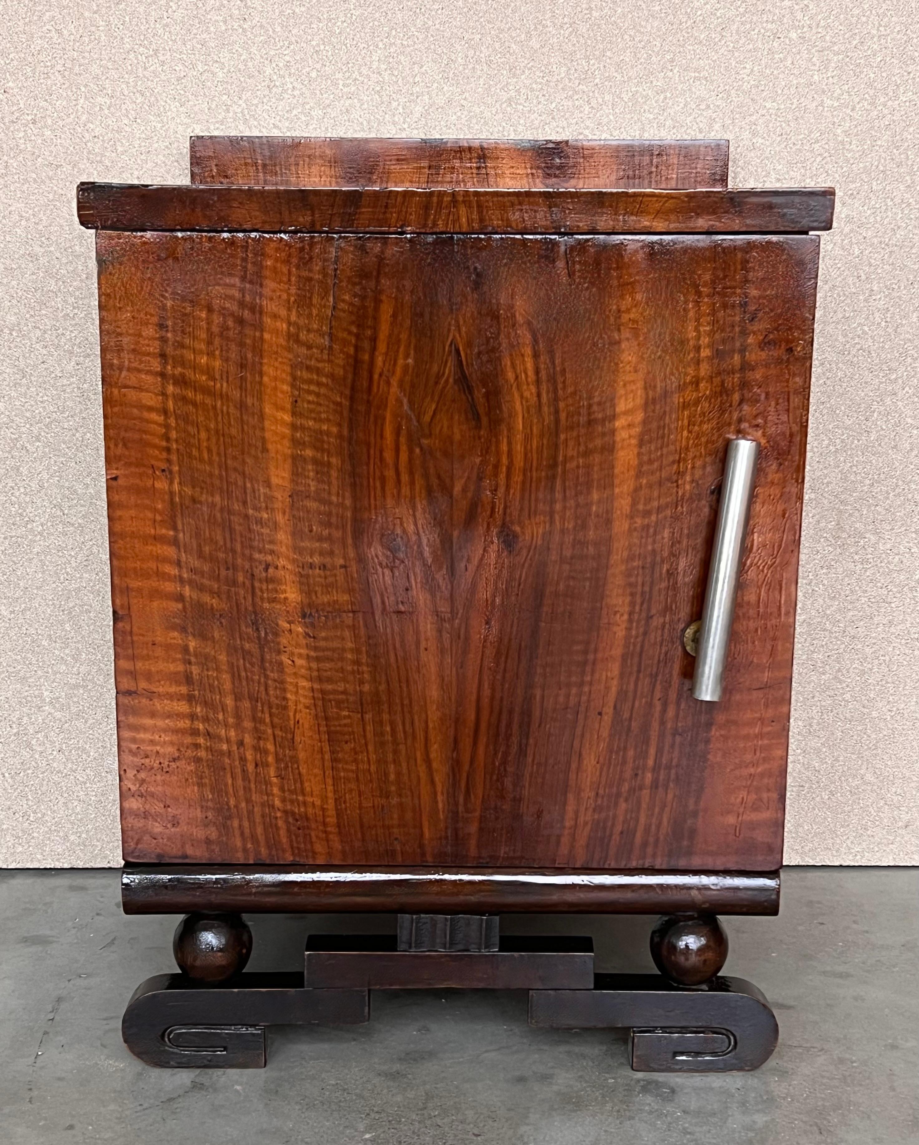This pair of circa 1930s French Art Deco side cabinets could be used to flank a sofa or as nightstands. Each has a storage compartment and one interior drawer and one ceramic box. Cabinets are set on ebonized trestle foot at the front.
 