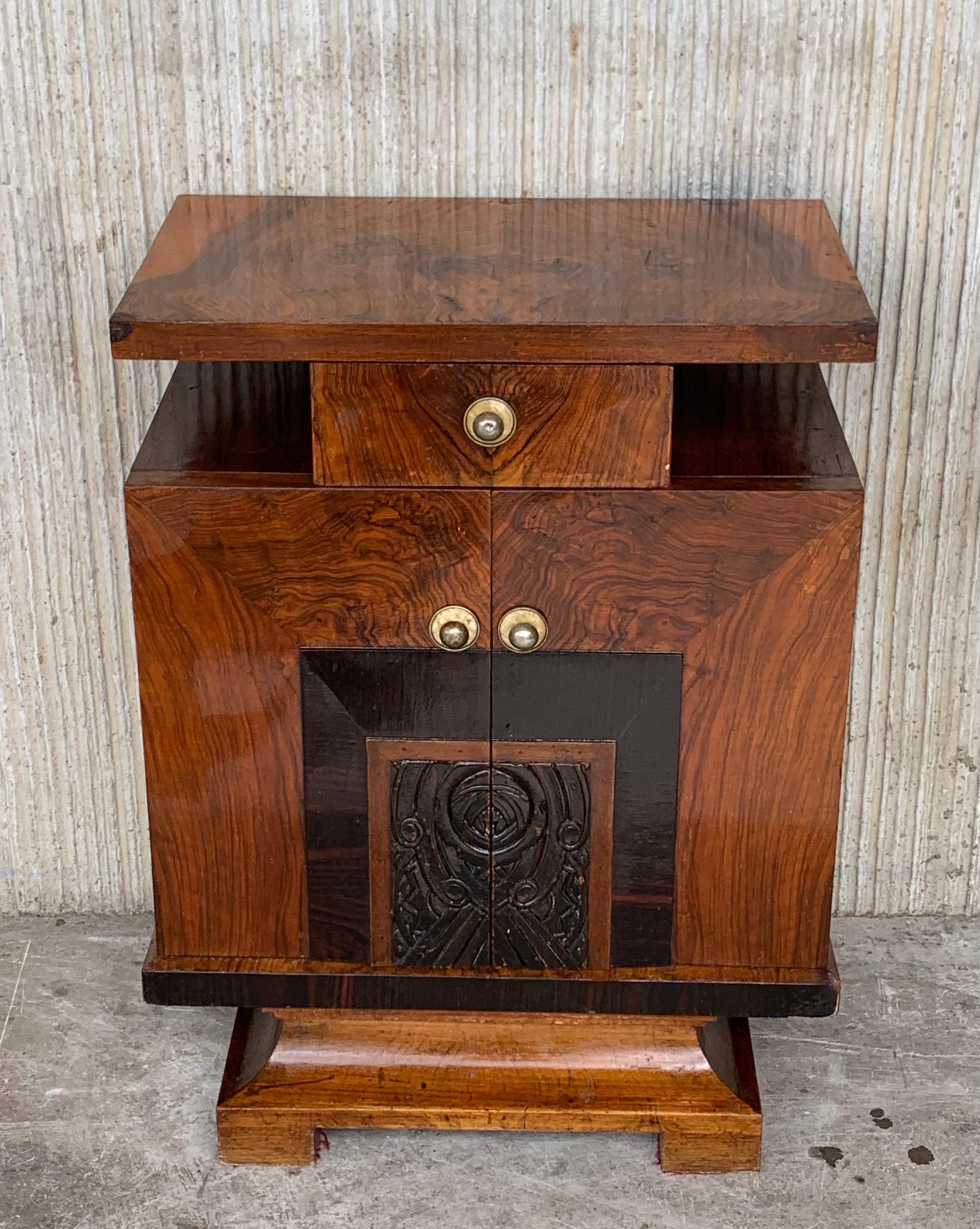This pair of circa 1930s French Art Deco side cabinets could be used to flank a sofa or as nightstands. Each has a storage compartment with hinged door and narrow open shelves at the sides. One-drawer and one box. Cabinets are set on ebonized