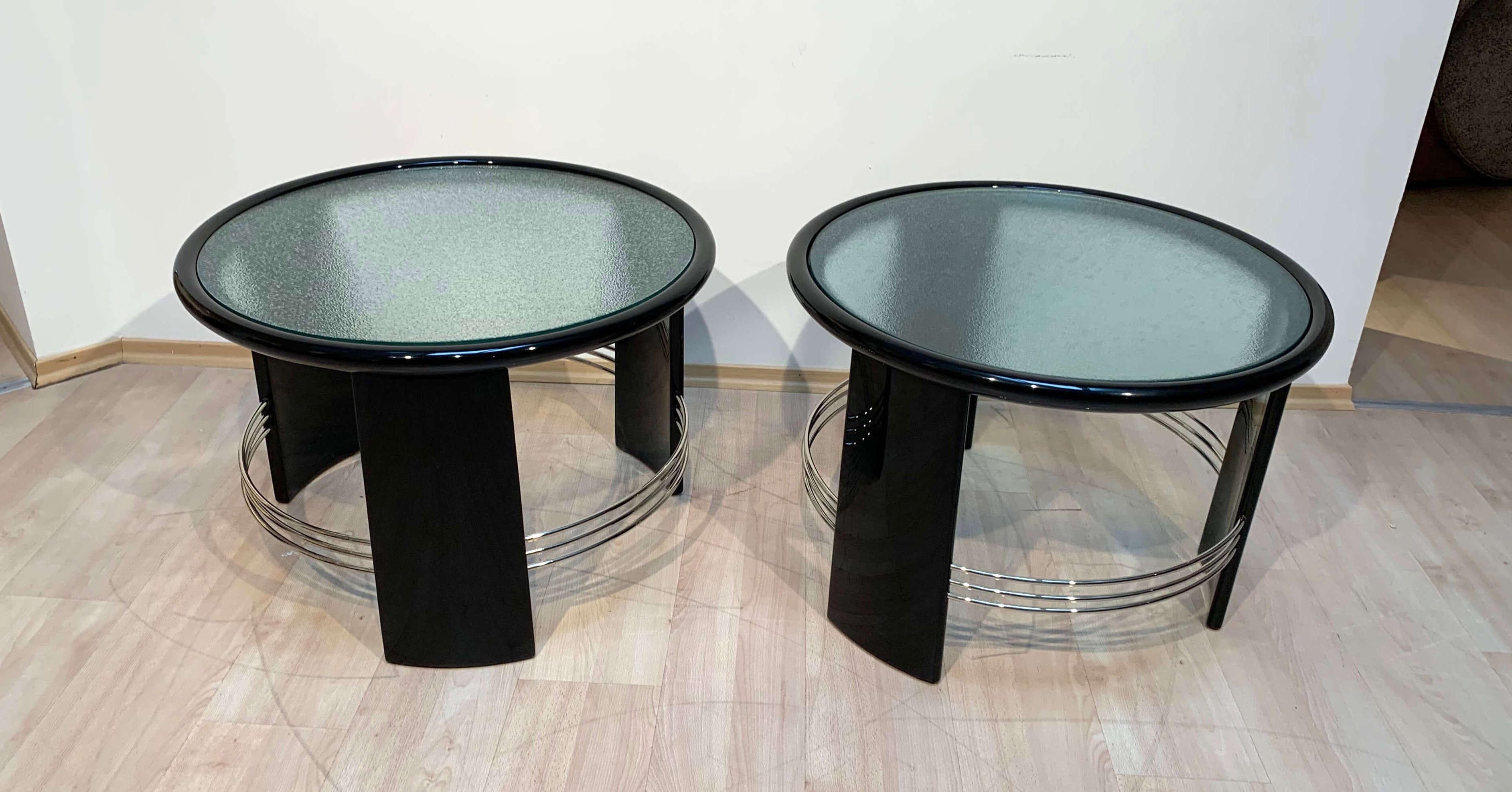 Beautiful pair of big, round and excellently restored Art Deco side, sofa, end or coffee tables from France about 1930.
 
Black high-gloss lacquer on solid oak wood. Old frosted glass to take out. Nickel-plated metal bars.
 
Fully restored condition.