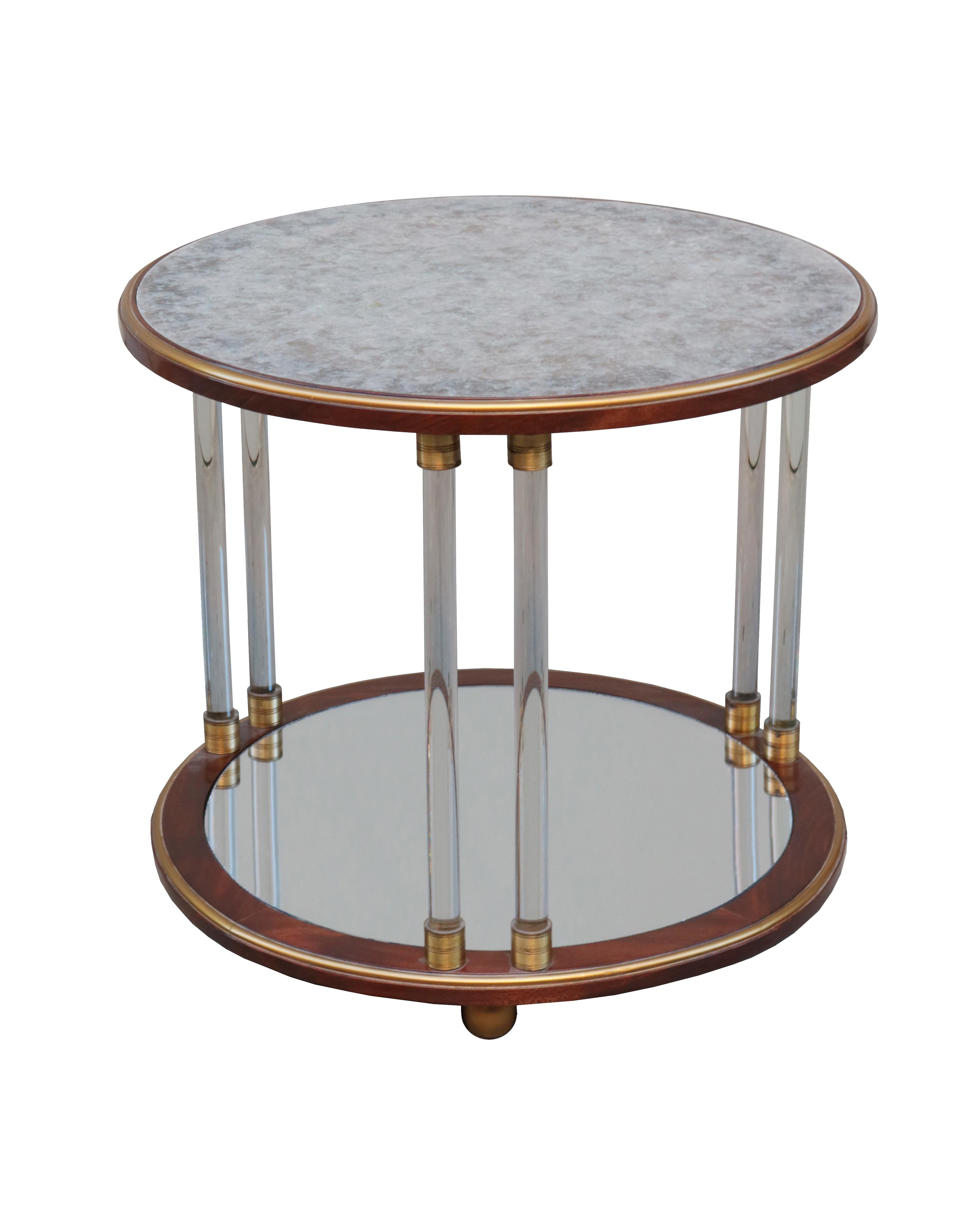 A pair of Art Deco round two-tier side tables.
Mahogany with
A pair of Art Deco two-tier round side tables.
Mahogany with mica tops, glass legs,
patinated brass details, giltwood feet
and mirrored bottom tier.


 