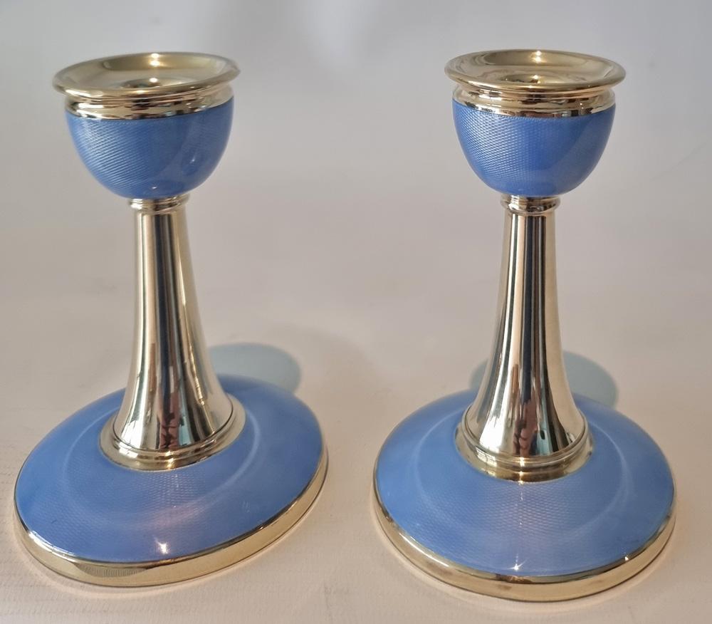 A fine pair of Art Deco silver and blue guilloche enamel candlesticks. Silver hallmarks for sterling silver, Birmingham, and date mark for 1929 and makers mark. 