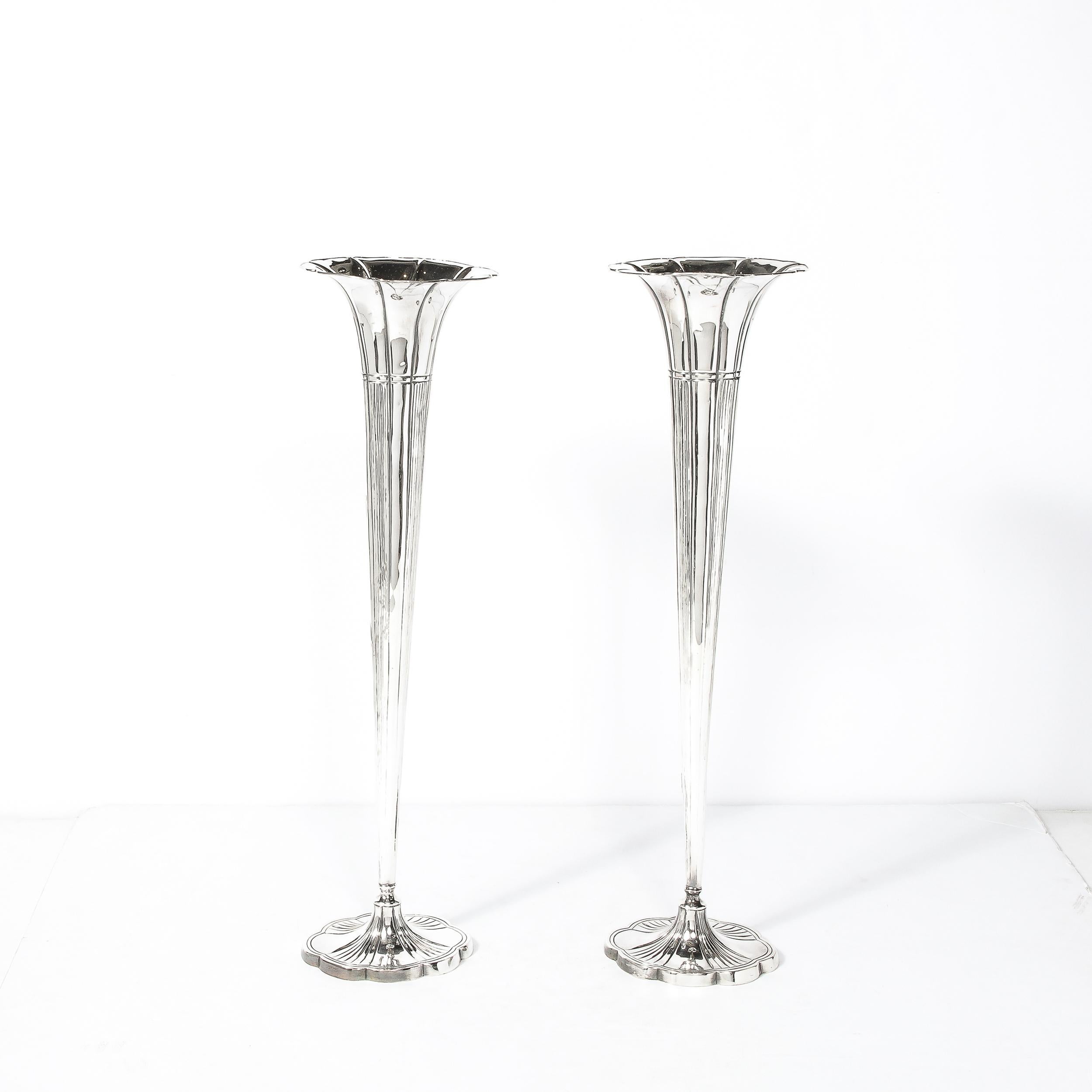 This Pair of Art Deco Silver Plate Fluted Trumpet Vases Originate from the United States Circa 1930. 
Elegant, tall and slender, they achieve a beautiful balance of geometric design and execution using organic forms. Made in weighted sterling