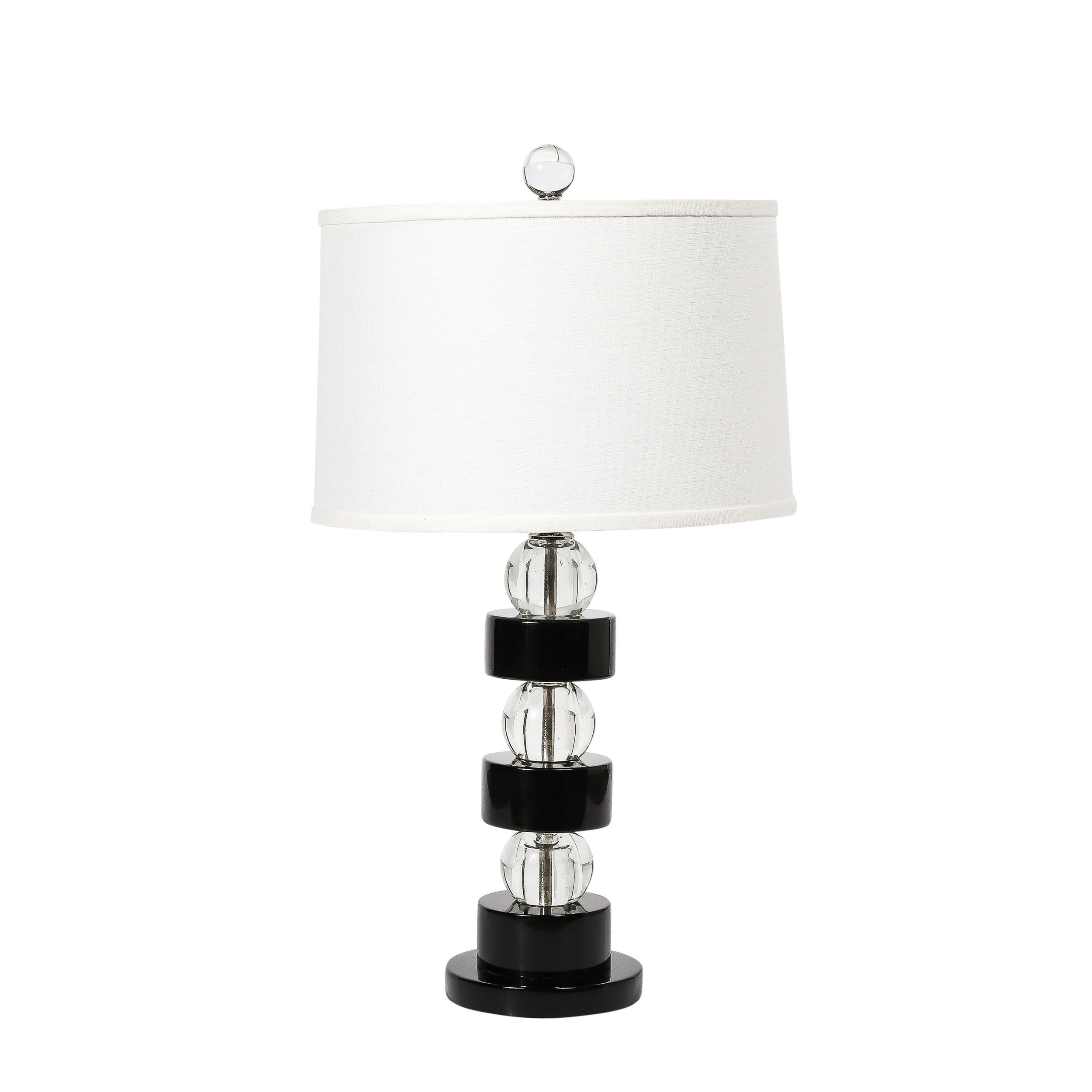 This unique and sophisticated Pair of Art Deco Stacked Black Lacquer and Glass Ball Table Lamps are by Russel Wright  and originate from the United States, Circa 1930. They feature a stacked construction composed of brilliant black lacquered