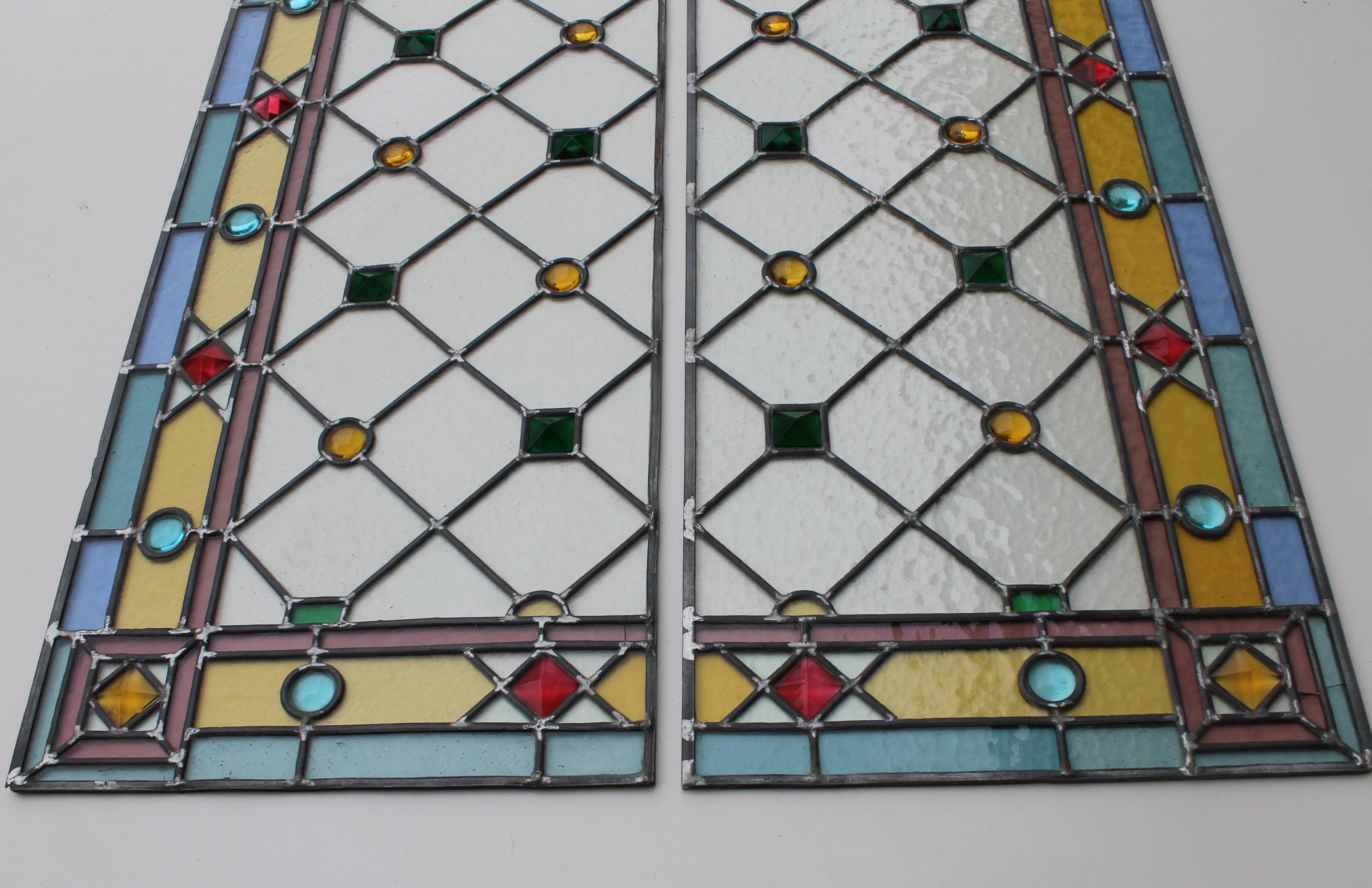 Two decorated stained glass panels, completely restored, dated, circa 1935.

