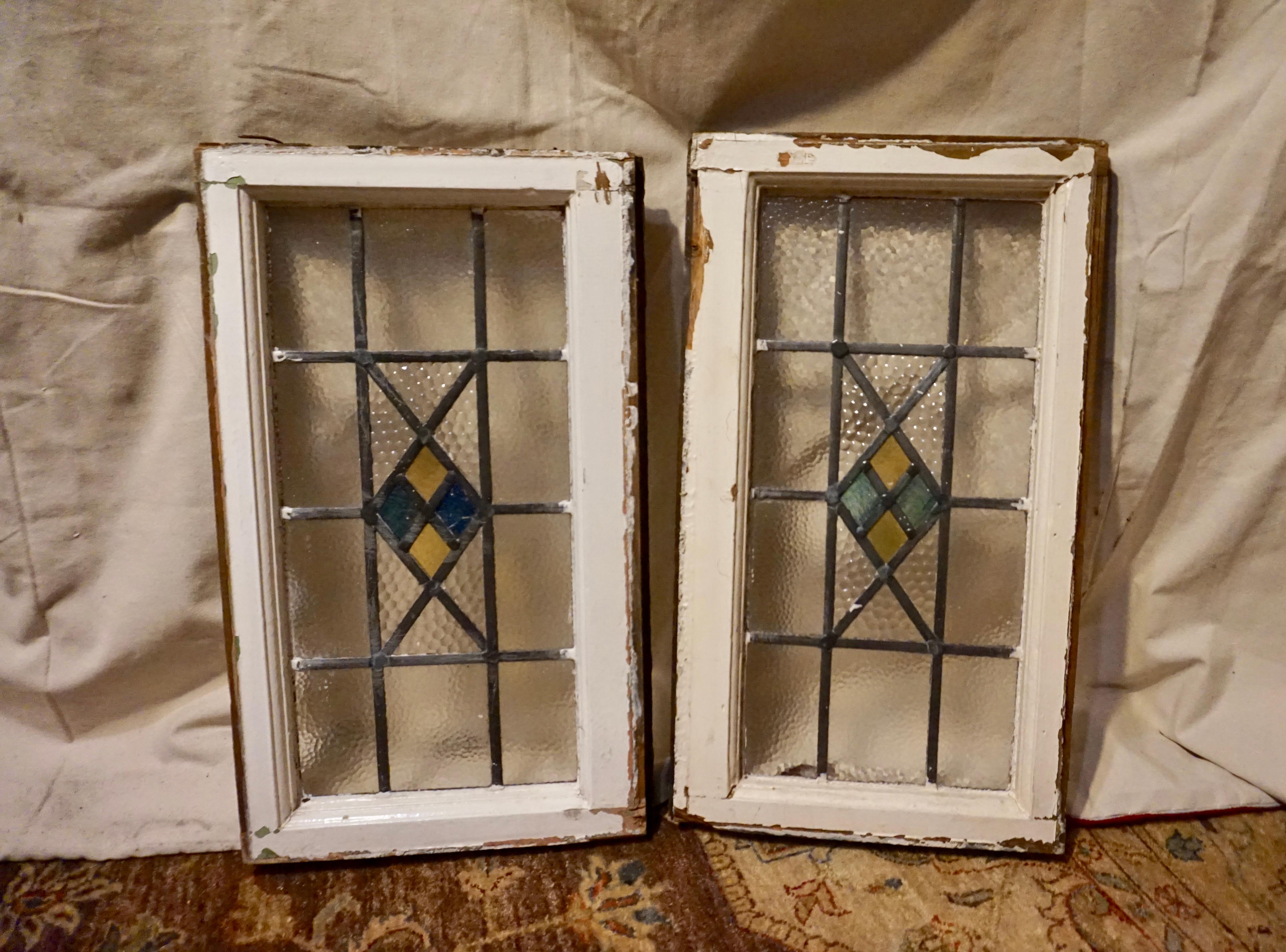 Elegant Art Deco stained glass windows with geometric motifs and pebbled translucent glass. Nice specimens from the period. Sturdy frames. Minor crack in centre of one pane and some edge putty missing otherwise in well preserved original condition.