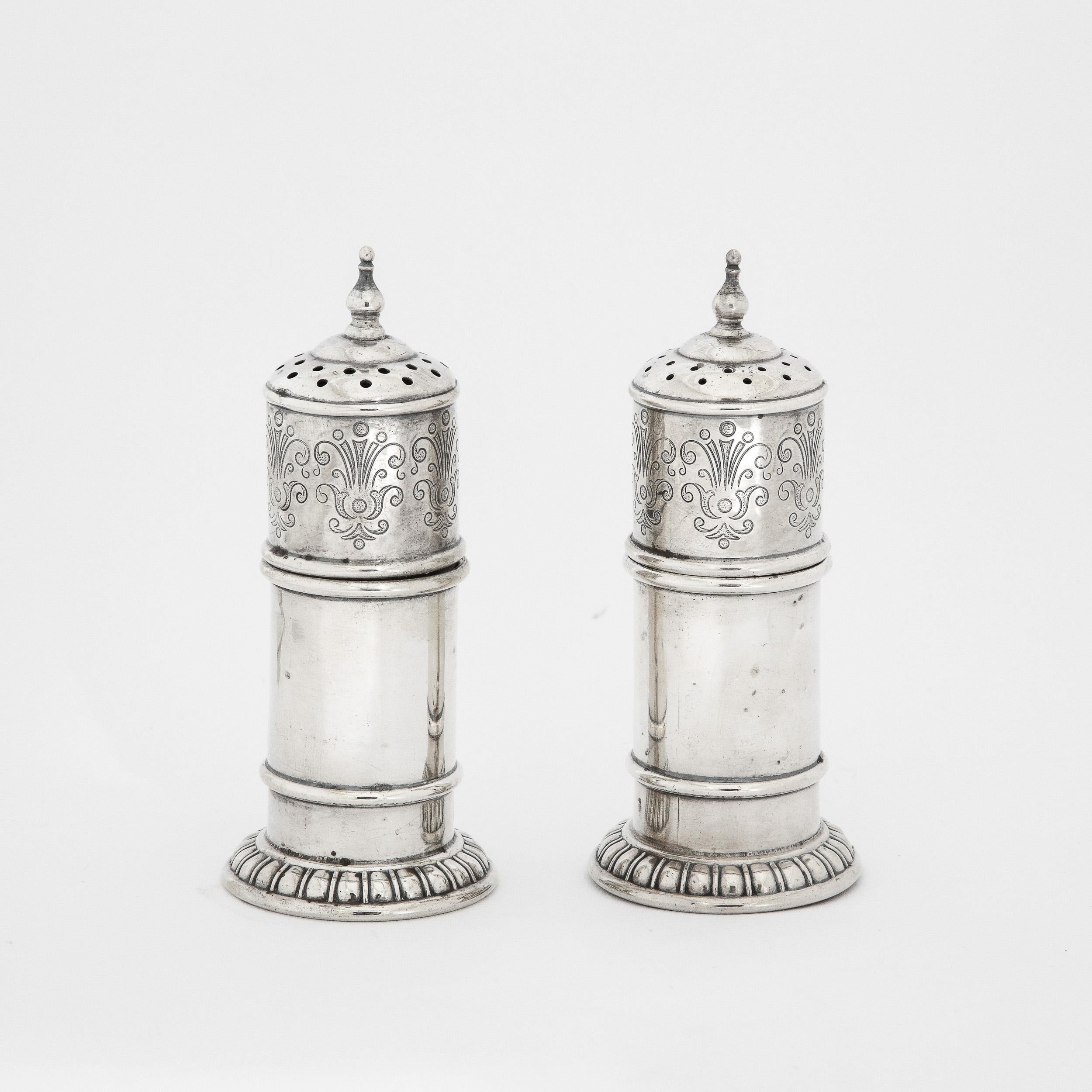 These stunning Art Deco Salt and Pepper Shakers originate from the United States, Circa 1930, and are executed  by the company Rogers, Lunt and Bowlen Co. The hand-chased detailing is beautifully precise, depicting geometrically stylized looping