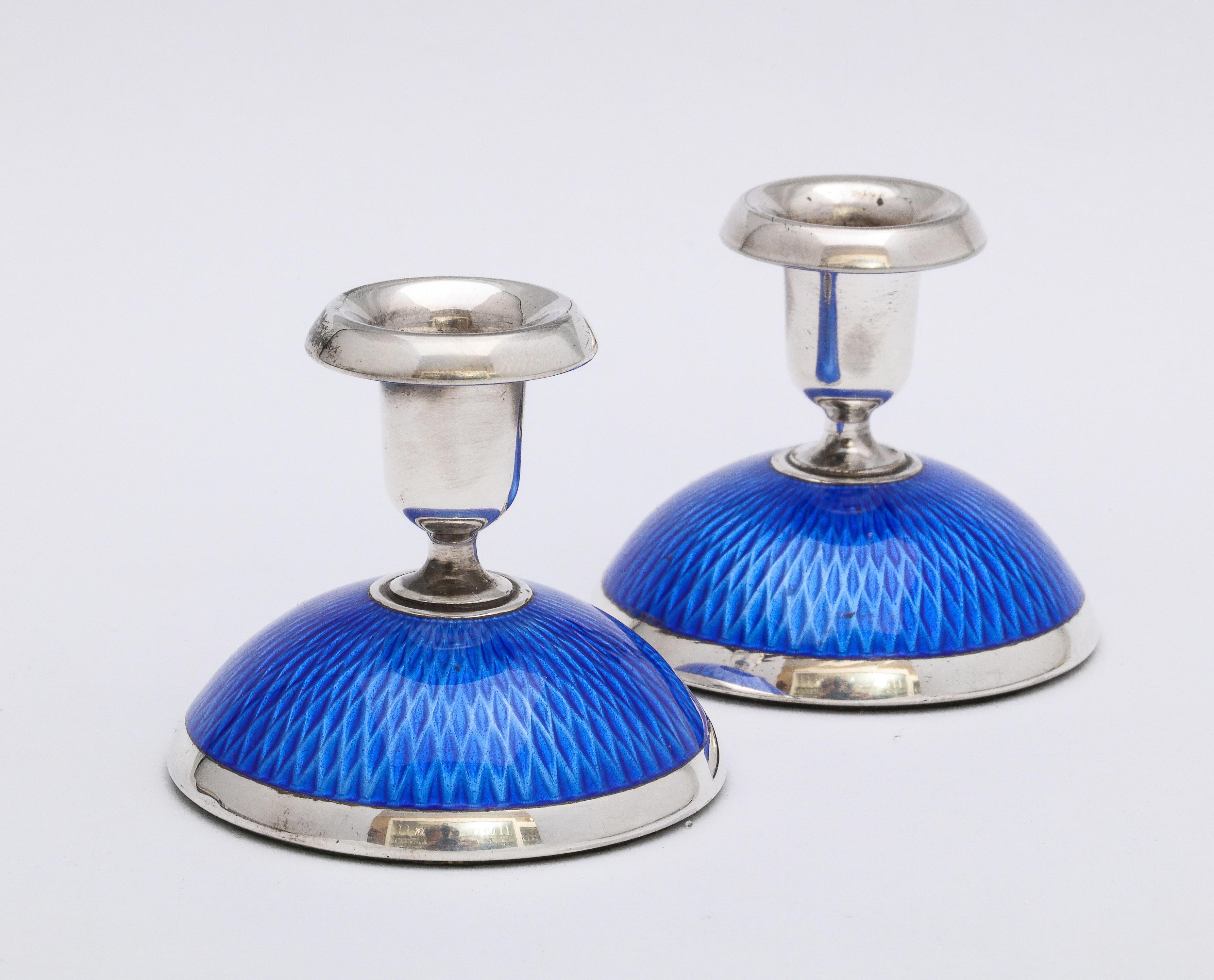 Pair of Art Deco, sterling silver and dark blue guilloche enamel candlesticks, Oslo, Norway, circa 1930s, Norsk Solwarreindustri - makers. Dark blue guilloche enamel seems to shimmer in the light. Each candlestick measures 2 inches high x 2 inches