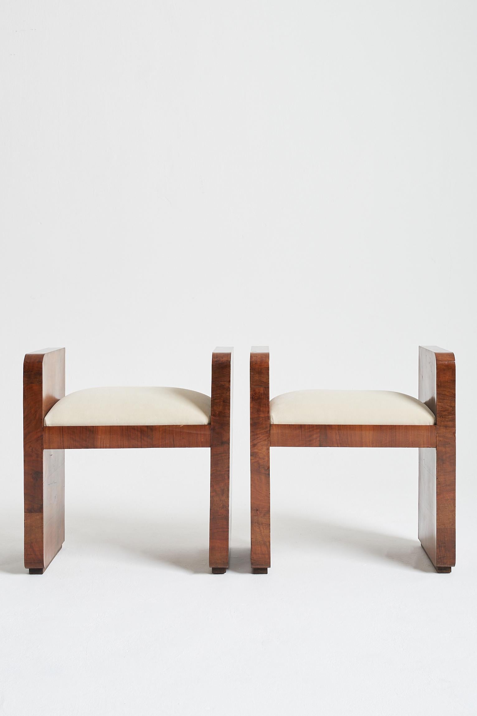 A pair of Art Deco walnut veneered stools, upholstered in cream velvet.
France, circa 1930.