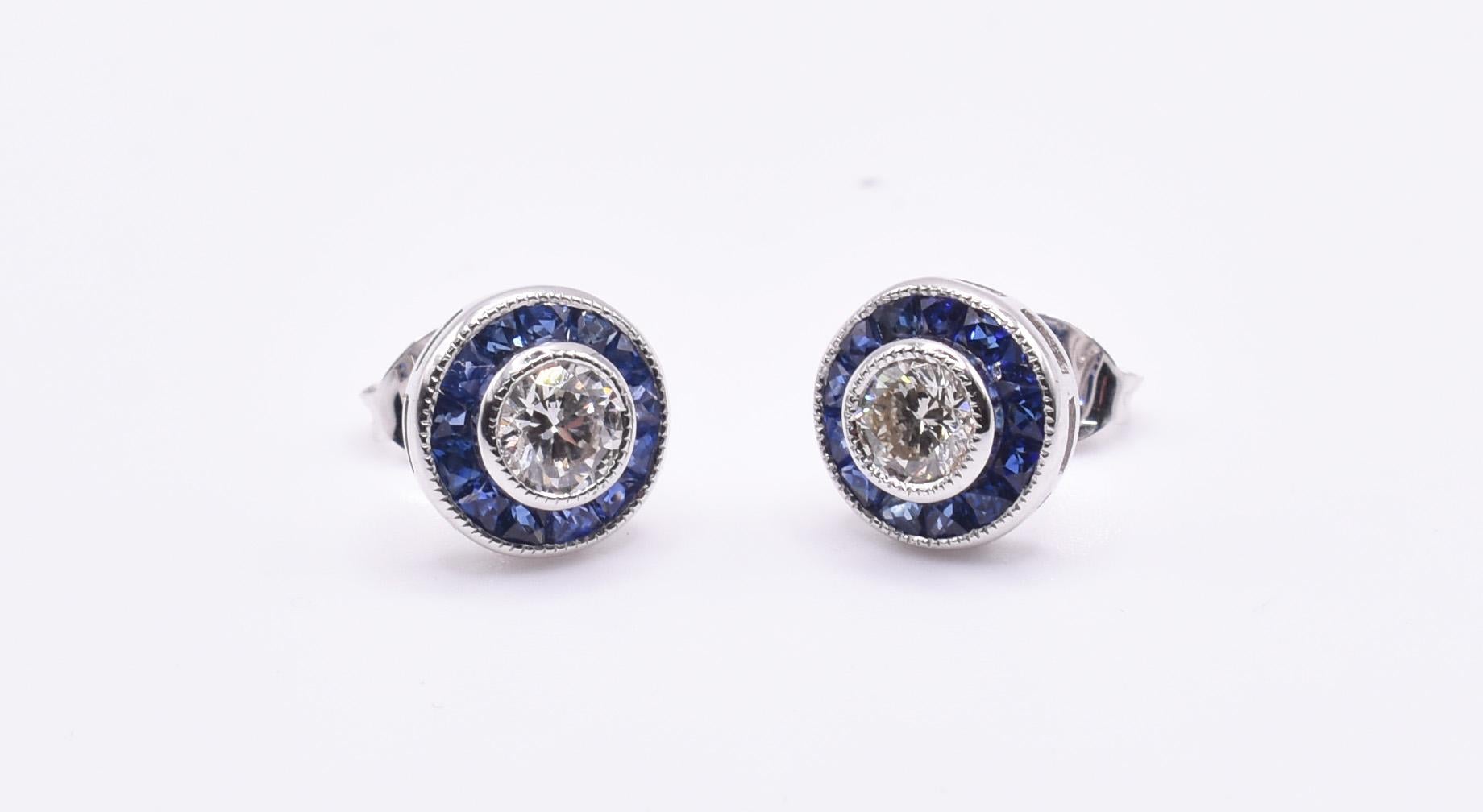 A splendid pair of 18k white gold diamond and sapphire earrings, featuring a lovely bezel set sapphires with round brilliant cut diamonds to the centre.

Metal: 18k White Gold
Total Carat Weight: 0.50ct (per ear)