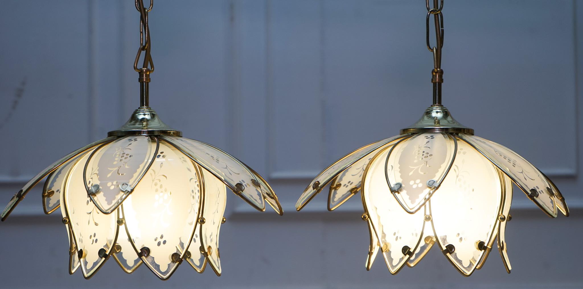 
Antiques of London


A stunning pair of Art Deco-style ceiling lamps dating from the 1960s, designed in the elegant form of lotus flowers. Each lamp is crafted from frosted and clear glass petals, beautifully decorated with etched grape and leaf