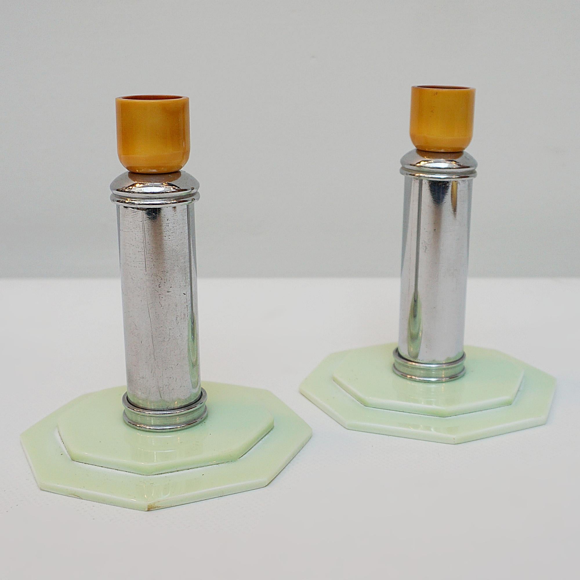A pair of Art Deco style candlesticks. A chromed cylindrical stem, set over an octagonal mint stepped bakelite base. Amber bakelite candle cup top.

Dimensions: H 13cm W 10cm

Origin: English

Item Number: 0812232

Re-chromed and polished with some