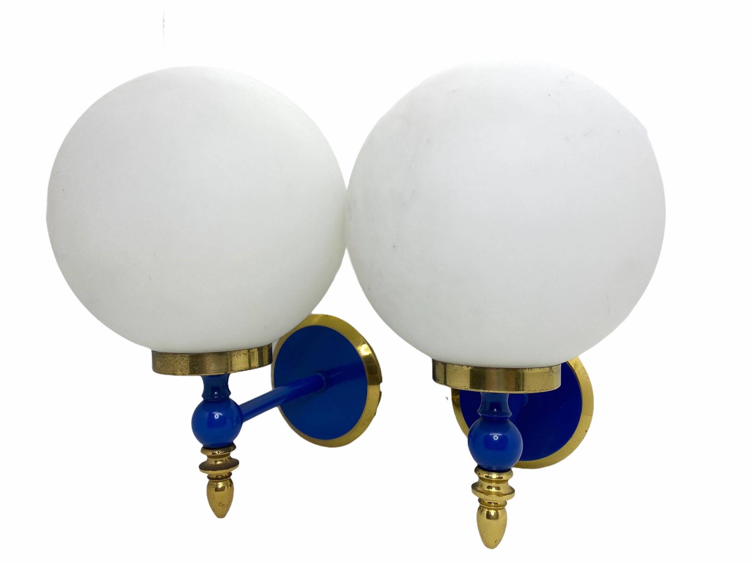 Pair of Art Deco style blue lacquered brass and milk glass sconces, Germany, each fixture requires a European E14 candelabra bulb, up to 60 watts. The wall lights have a beautiful brass frame with blue lacquered parts and give each room a eclectic