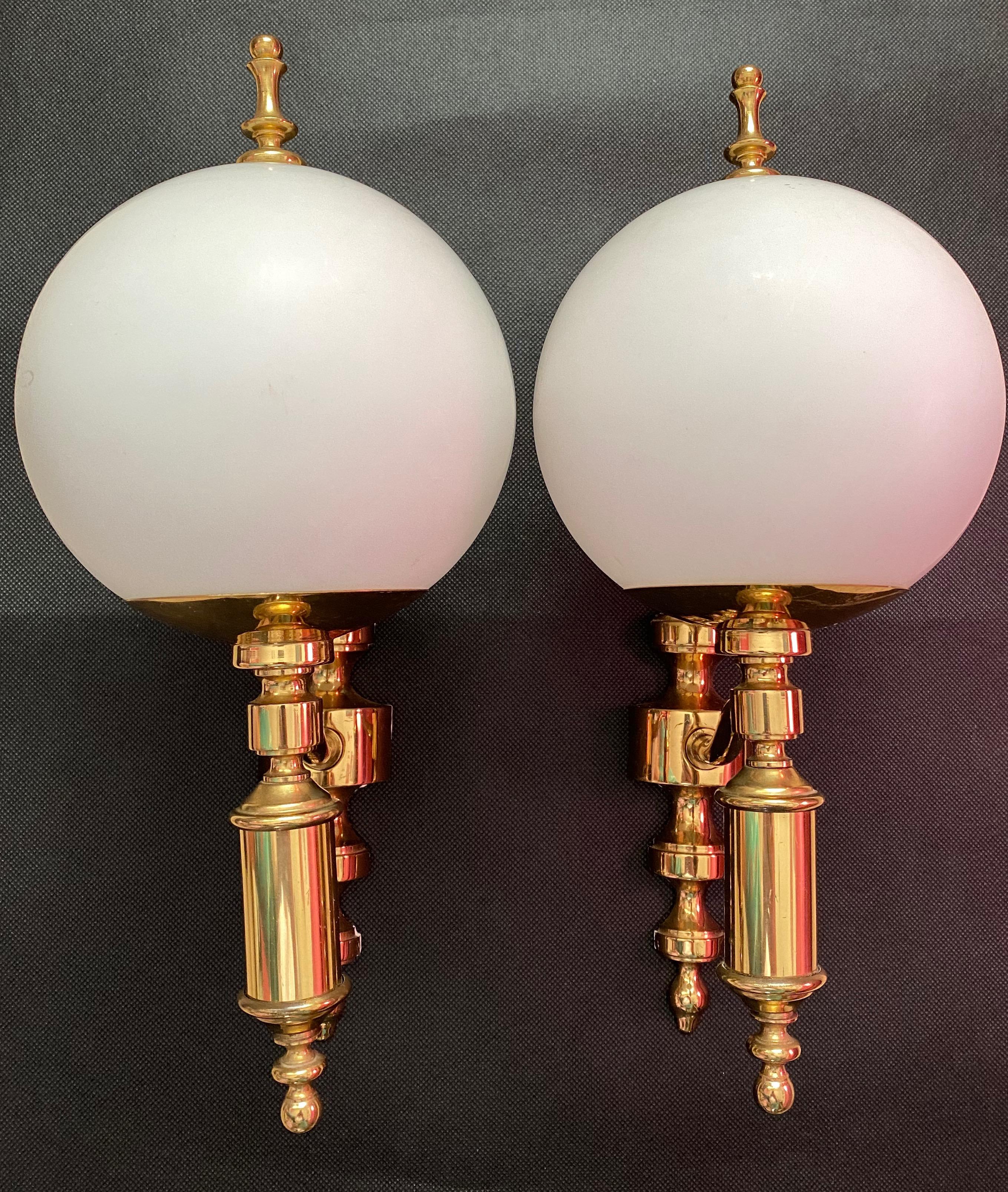 Pair of Art Deco style brass and milk glass sconces made by Soelken Leuchten, Germany, each fixture requires a European E14 candelabra bulb, up to 60 watts. The wall lights have a beautiful brass frame and give each room a eclectic statement.